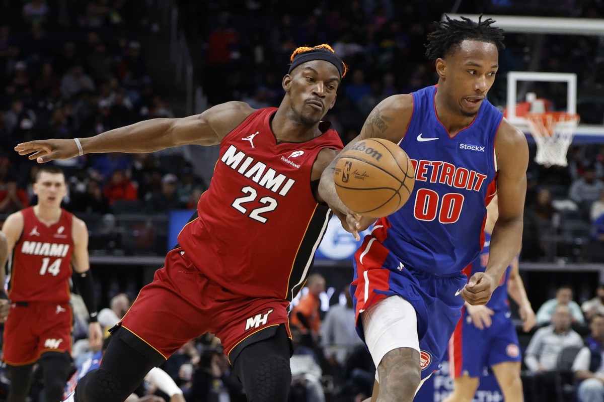 Miami Heat forward Jimmy Butler (22) knocks the ball away from Detroit Pistons forward Ronald Holland II (00) in the second half at Little Caesars Arena. Mandatory Credit: Rick Osentoski-Imagn Images