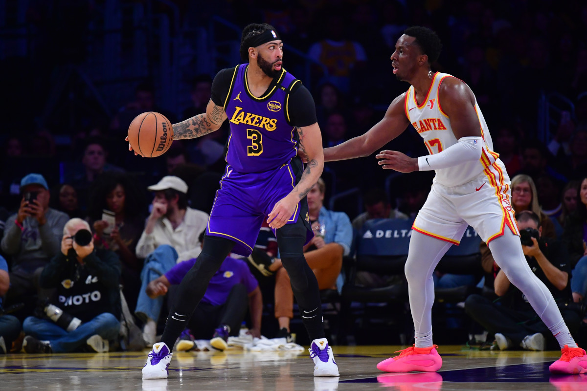 Jan 3, 2025; Los Angeles, California, USA; Los Angeles Lakers forward Anthony Davis (3) moves the ball against Atlanta Hawks forward Onyeka Okongwu (17) during the first half at Crypto.com Arena. Mandatory Credit: Gary A. Vasquez-Imagn Images  