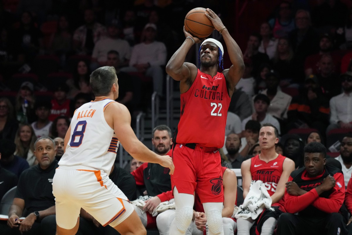 Miami, Florida, USA; Miami Heat forward Jimmy Butler (22) shoots the ball against Phoenix Suns guard Grayson Allen (8) during the second half at Kaseya Center. Mandatory Credit: Jim Rassol-Imagn Images