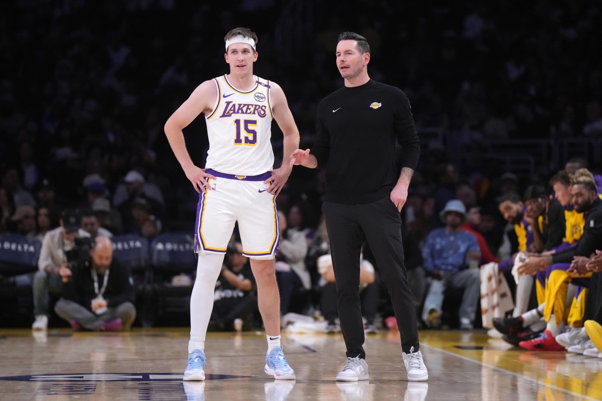 Dec 15, 2024; Los Angeles, California, USA; Los Angeles Lakers coach JJ Redick (right) talks with guard Austin Reaves (15) in the first half at Crypto.com Arena. Mandatory Credit: Kirby Lee-Imagn Images