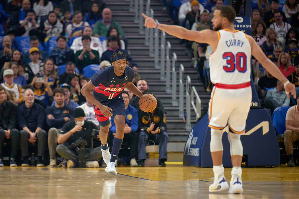 Jan 18, 2025; San Francisco, California, USA; Washington Wizards guard Bilal Coulibaly (0) brings the ball up court against Golden State Warriors guard Stephen Curry (30) during the first quarter at Chase Center. Mandatory Credit: Robert Edwards-Imagn Images  