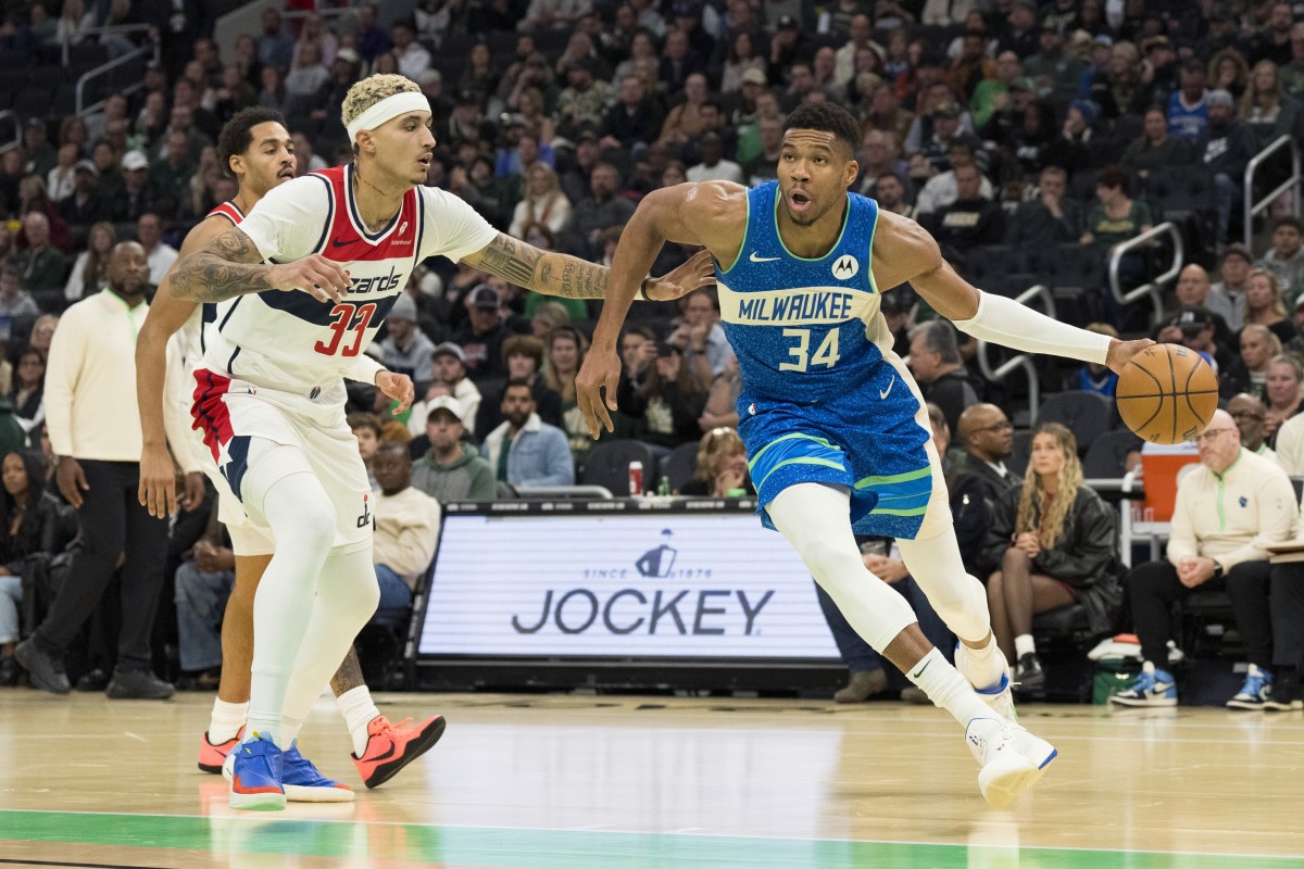 Milwaukee Bucks forward Giannis Antetokounmpo (34) drives for the basket around Washington Wizards forward Kyle Kuzma (33) during the third quarter at Fiserv Forum. Mandatory Credit: Jeff Hanisch-Imagn Images