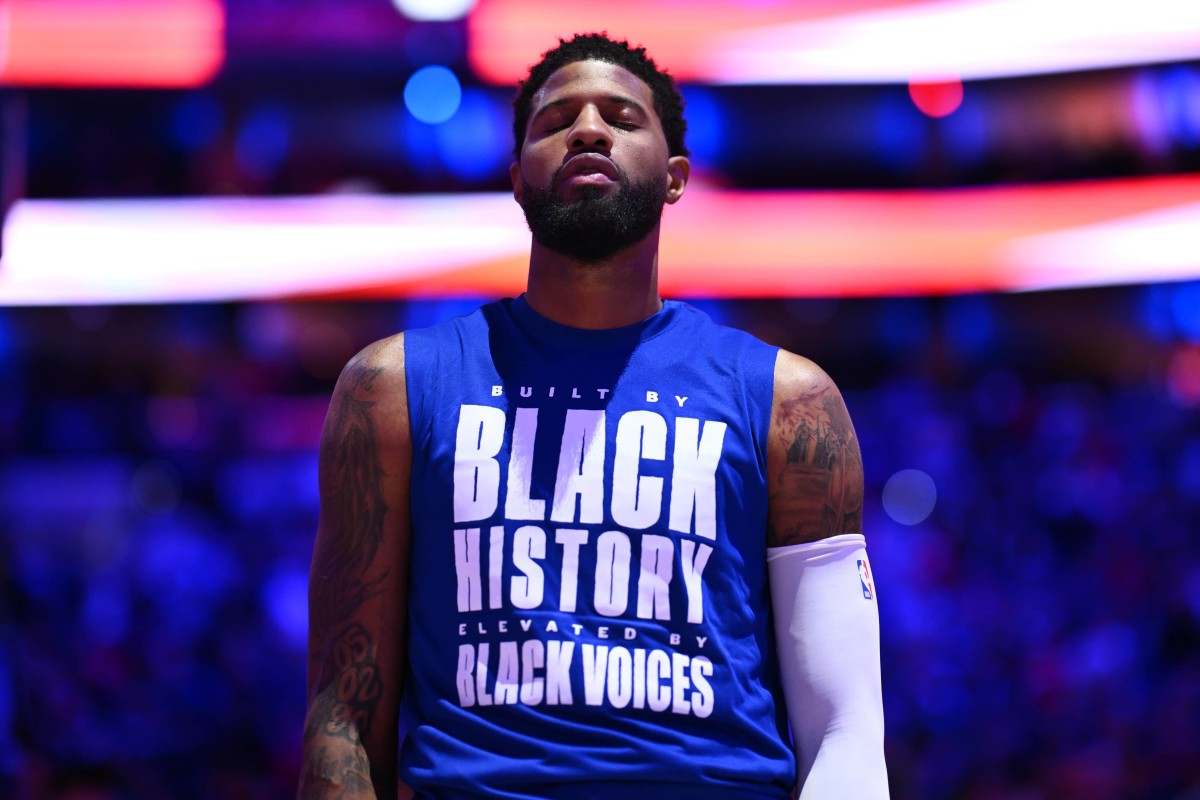 Philadelphia 76ers forward Paul George (8) observes the national anthem before the game against the Miami Heat at Wells Fargo Center.