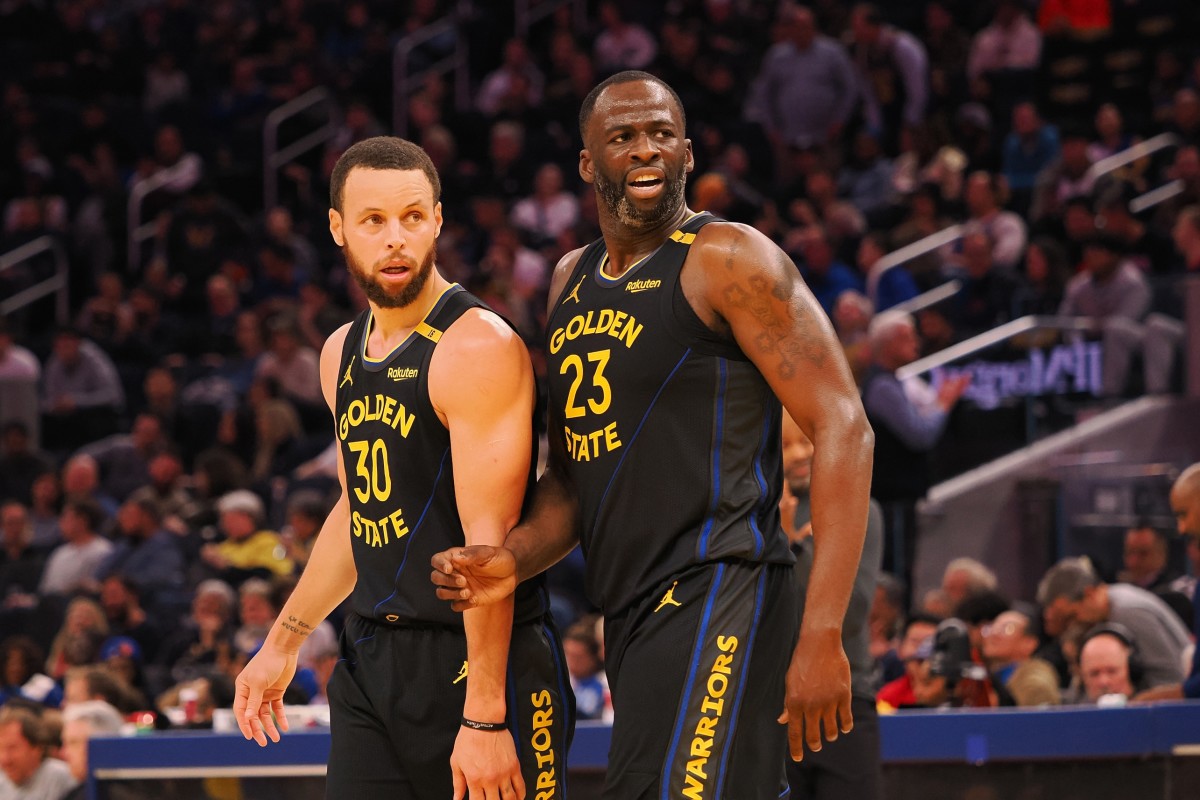 Golden State Warriors guard Stephen Curry (30) and forward Draymond Green (23) look towards an Orlando Magic player at half time at Chase Center. Mandatory Credit: Kelley L Cox-Imagn Images