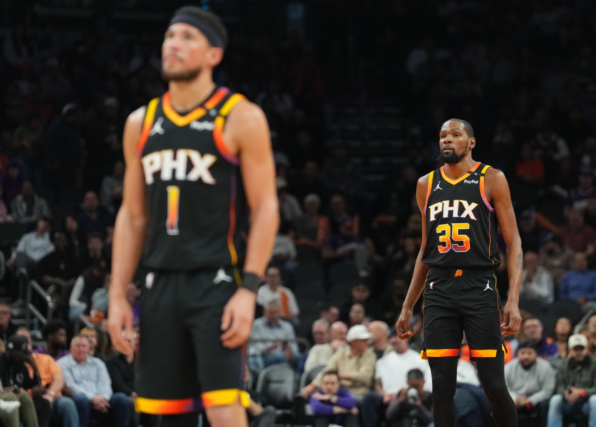 Phoenix Suns guard Devin Booker (1) and Phoenix Suns forward Kevin Durant (35) look on against the Memphis Grizzlies during the first half at Footprint Center. Mandatory Credit: Joe Camporeale-Imagn Images