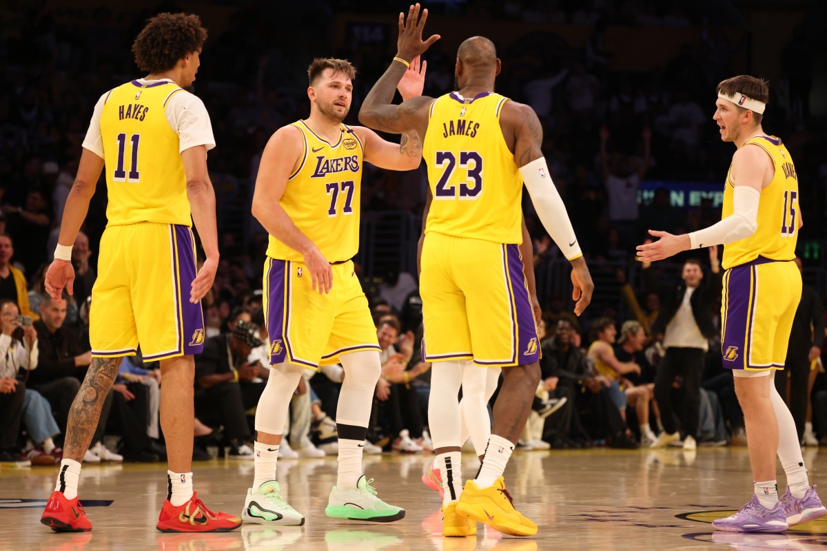 Los Angeles Lakers guard Luka Doncic (77) celebrates with forward LeBron James (23) after making a basket during the fourth quarter against the Minnesota Timberwolves at Crypto.com Arena. Mandatory Credit: Jason Parkhurst-Imagn Images