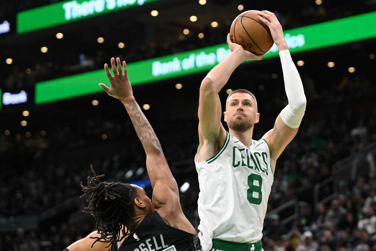 Boston Celtics center Kristaps Porzingis (8) attempts a basket against San Antonio Spurs guard Devin Vassell (24) during the first quarter at the TD Garden. Mandatory Credit: Brian Fluharty-Imagn Images