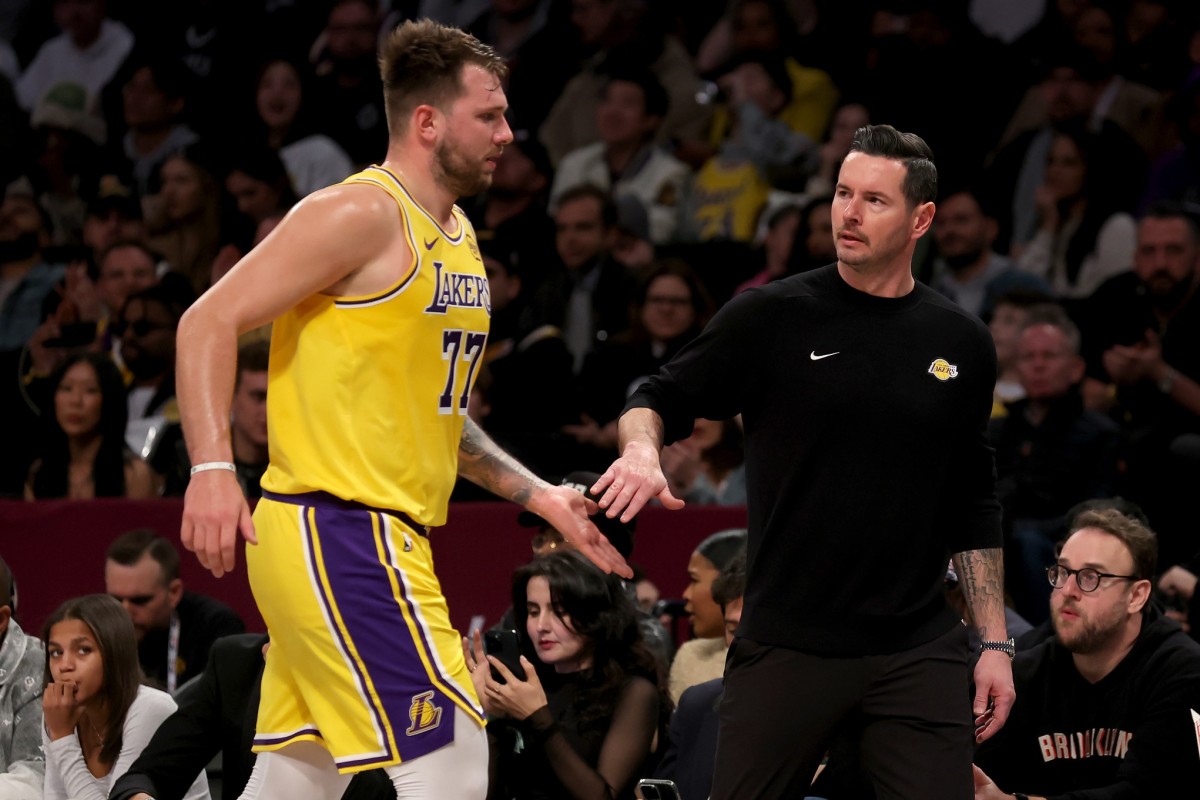 Mar 10, 2025; Brooklyn, New York, USA; Los Angeles Lakers guard Luka Doncic (77) high-fives head coach JJ Redick during the first quarter against the Brooklyn Nets at Barclays Center. Mandatory Credit- Brad Penner-Imagn Images