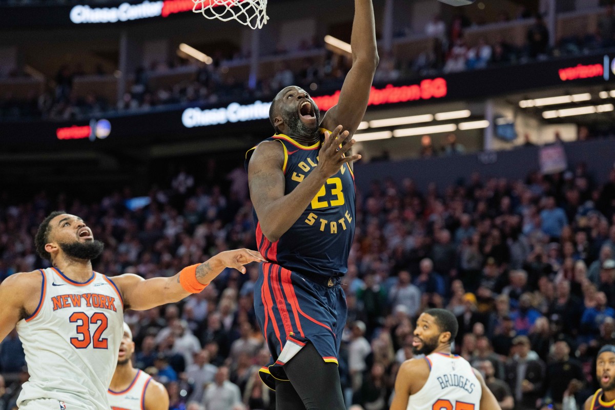 Golden State Warriors forward Draymond Green (23) shoots a layup against New York Knicks center Karl-Anthony Towns (32) during the fourth quarter at Chase Center. Mandatory Credit: Neville E. Guard-Imagn Images