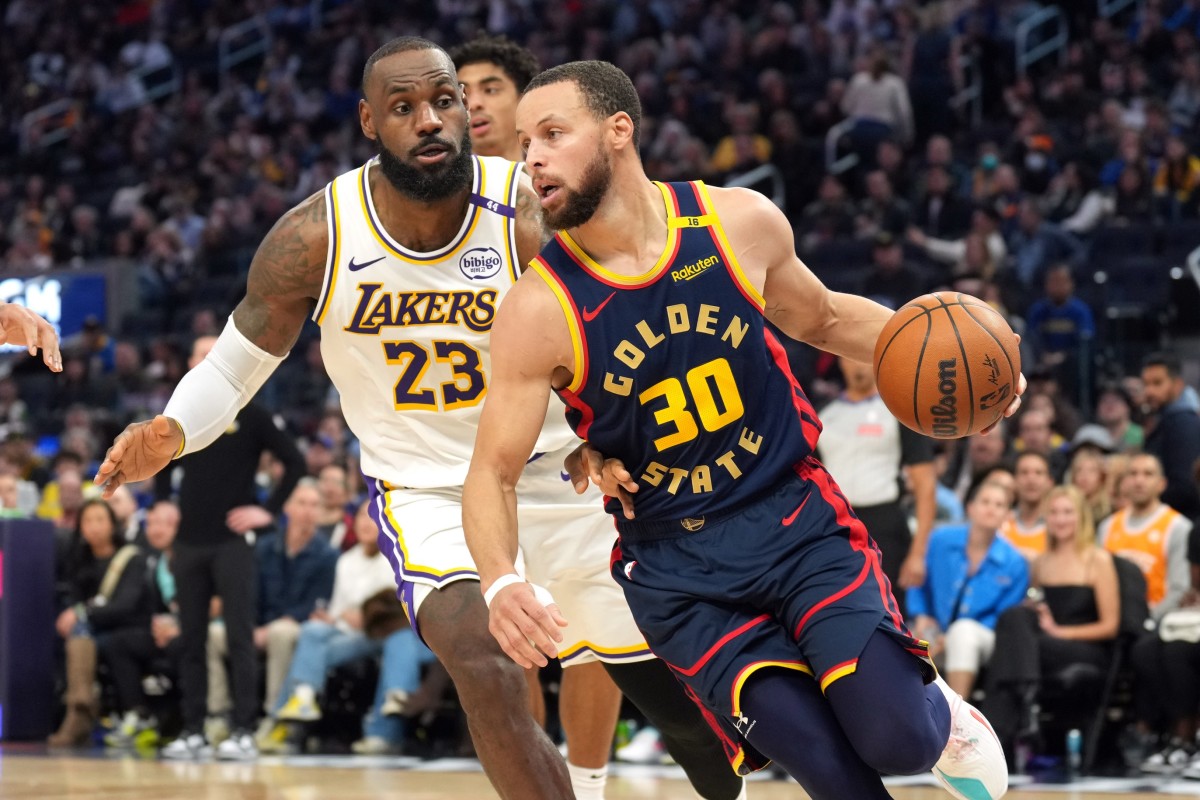 Golden State Warriors guard Stephen Curry (30) dribbles against Los Angeles Lakers forward LeBron James (23) during the third quarter at Chase Center. Mandatory Credit: Darren Yamashita-Imagn Images