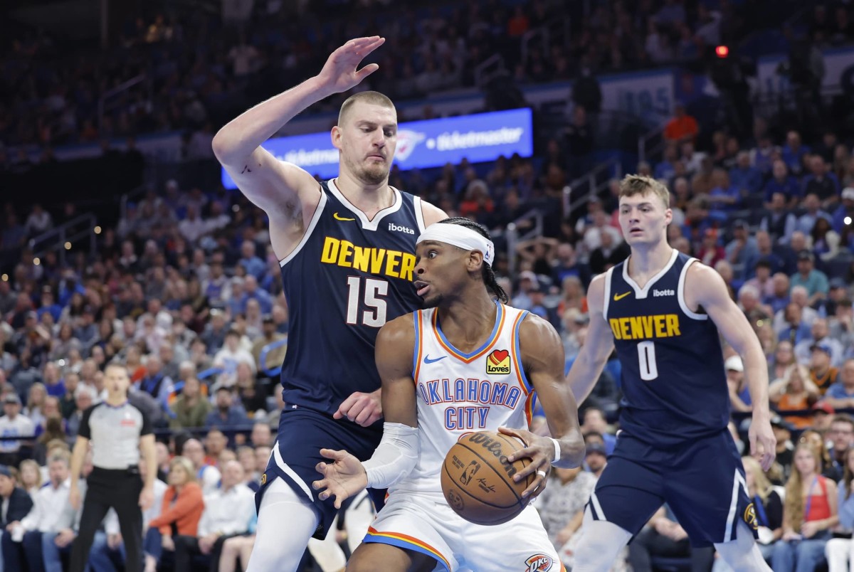 Mar 10, 2025; Oklahoma City, Oklahoma, USA; Denver Nuggets center Nikola Jokic (15) defends a drive by Oklahoma City Thunder guard Shai Gilgeous-Alexander (2) during the second half at Paycom Center. Mandatory Credit: Alonzo Adams-Imagn Images