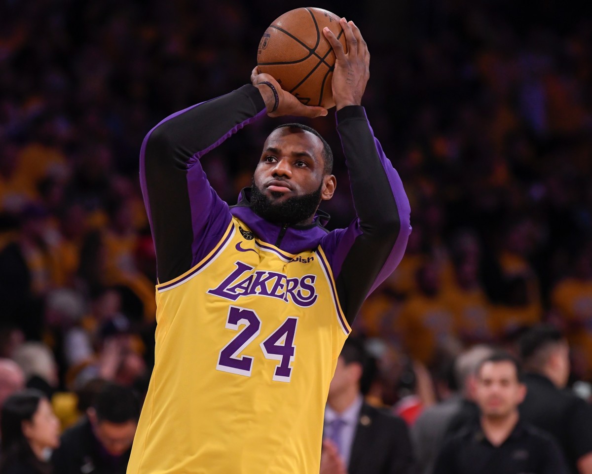 Los Angeles Lakers forward LeBron James shoots during pregame warmups before playing the Portland Trail Blazers at Staples Center. James along with the rest of the Lakers team wore jerseys with the number 8 or 24 to honor Kobe Bryant who died in a helicopter crash January 26, 2020. Mandatory Credit: Robert Hanashiro-Imagn Images
