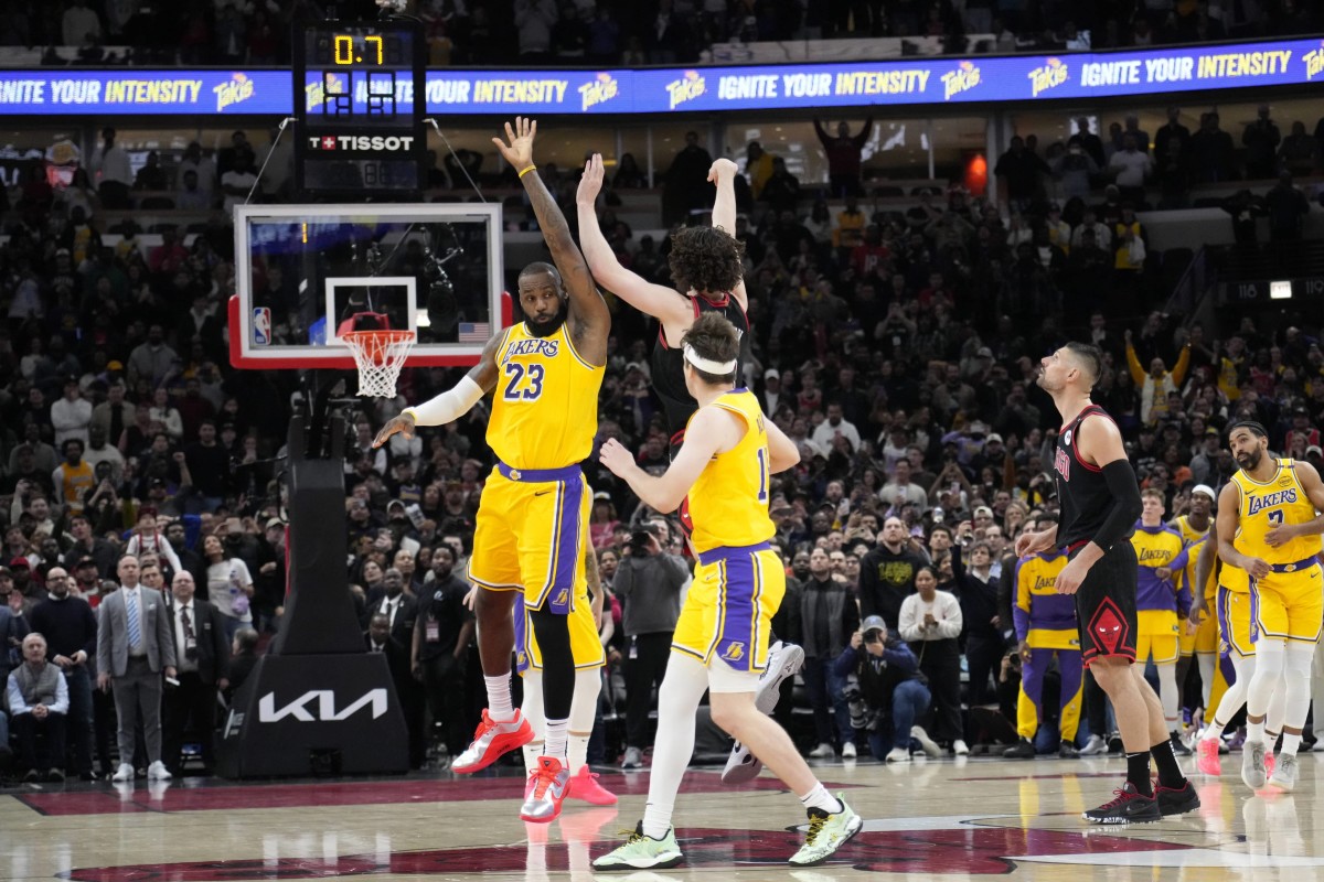 Mar 27, 2025; Chicago, Illinois, USA; Chicago Bulls guard Josh Giddey (3) makes the game winning three point basket as Los Angeles Lakers forward LeBron James (23) defends him during the second half at United Center. Mandatory Credit: David Banks-Imagn Images