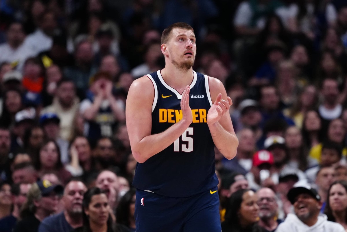 Denver Nuggets center Nikola Jokic (15) reacts in the third quarter against the Utah Jazz at Ball Arena.