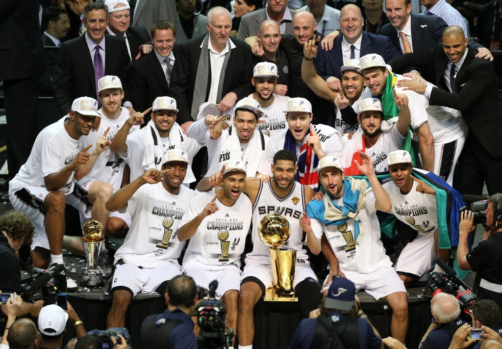 Jun 15, 2014; San Antonio, TX, USA; San Antonio Spurs pose for a photo with the Larry O'Brien trophy after the game against the Miami Heat in game five of the 2014 NBA Finals at AT&T Center. The Spurs defeated the Heat 104-87 to win the NBA Finals. Mandatory Credit: Soobum Im-USA TODAY Sports