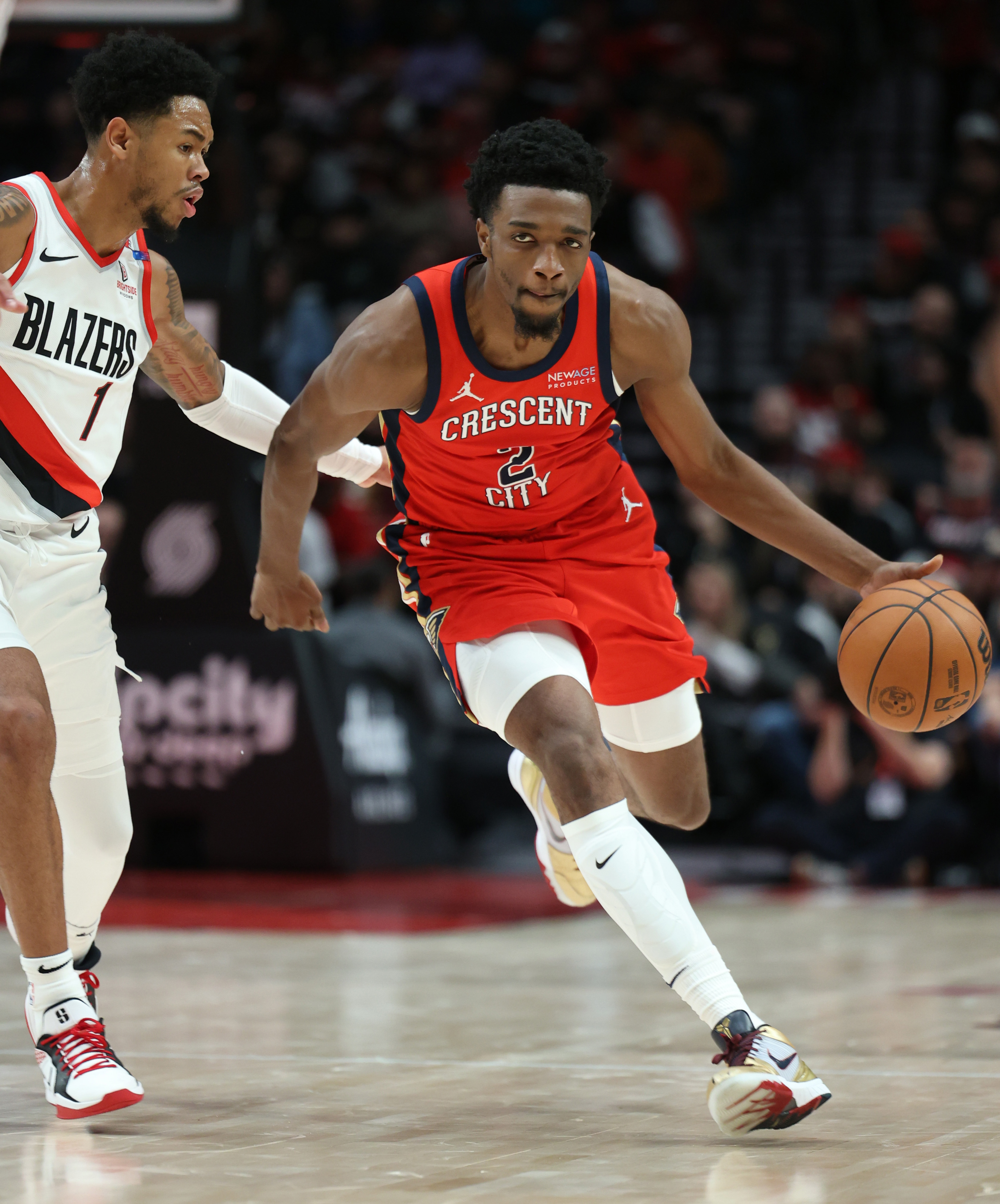 Oct 27, 2024; Portland, Oregon, USA; New Orleans Pelicans forward Herbert Jones (2) dribbles past Portland Trail Blazers guard Anfernee Simons (1) in the first half at Moda Center. Mandatory Credit: Jaime Valdez-Imagn Images
