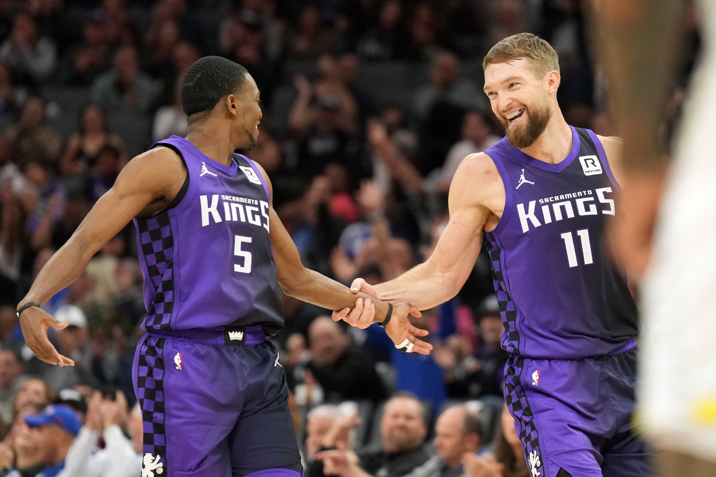 Feb 22, 2024; Sacramento, California, USA; Sacramento Kings guard De'Aaron Fox (5) dribbles around the pick set by forward Domantas Sabonis (10) during the fourth quarter at Golden 1 Center.
