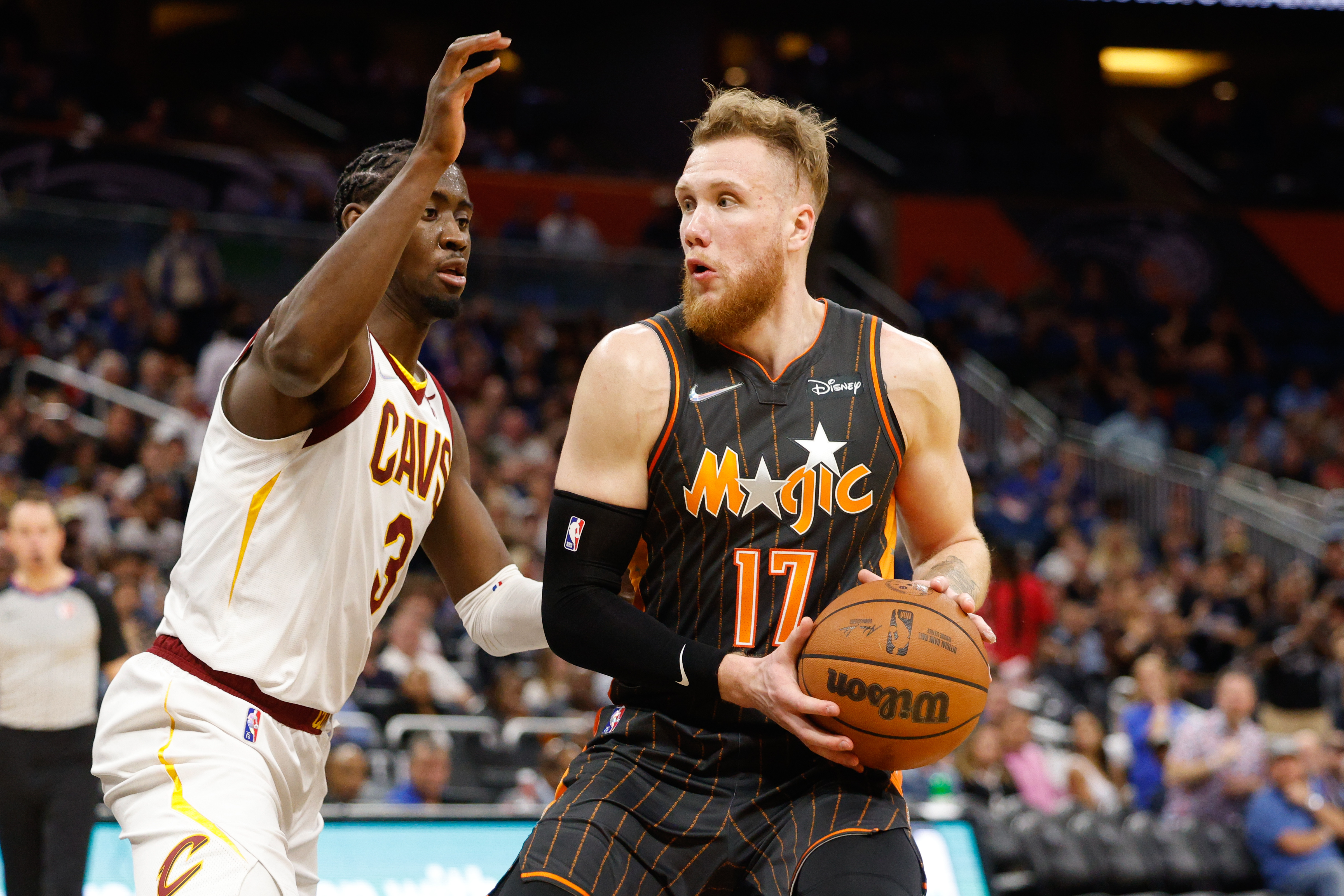 Apr 5, 2022; Orlando, Florida, USA; Orlando Magic forward Ignas Brazdeikis (17) looks to shoot the ball while guarded by Cleveland Cavaliers guard Caris LeVert (3) in the fourth quarter at Amway Center
