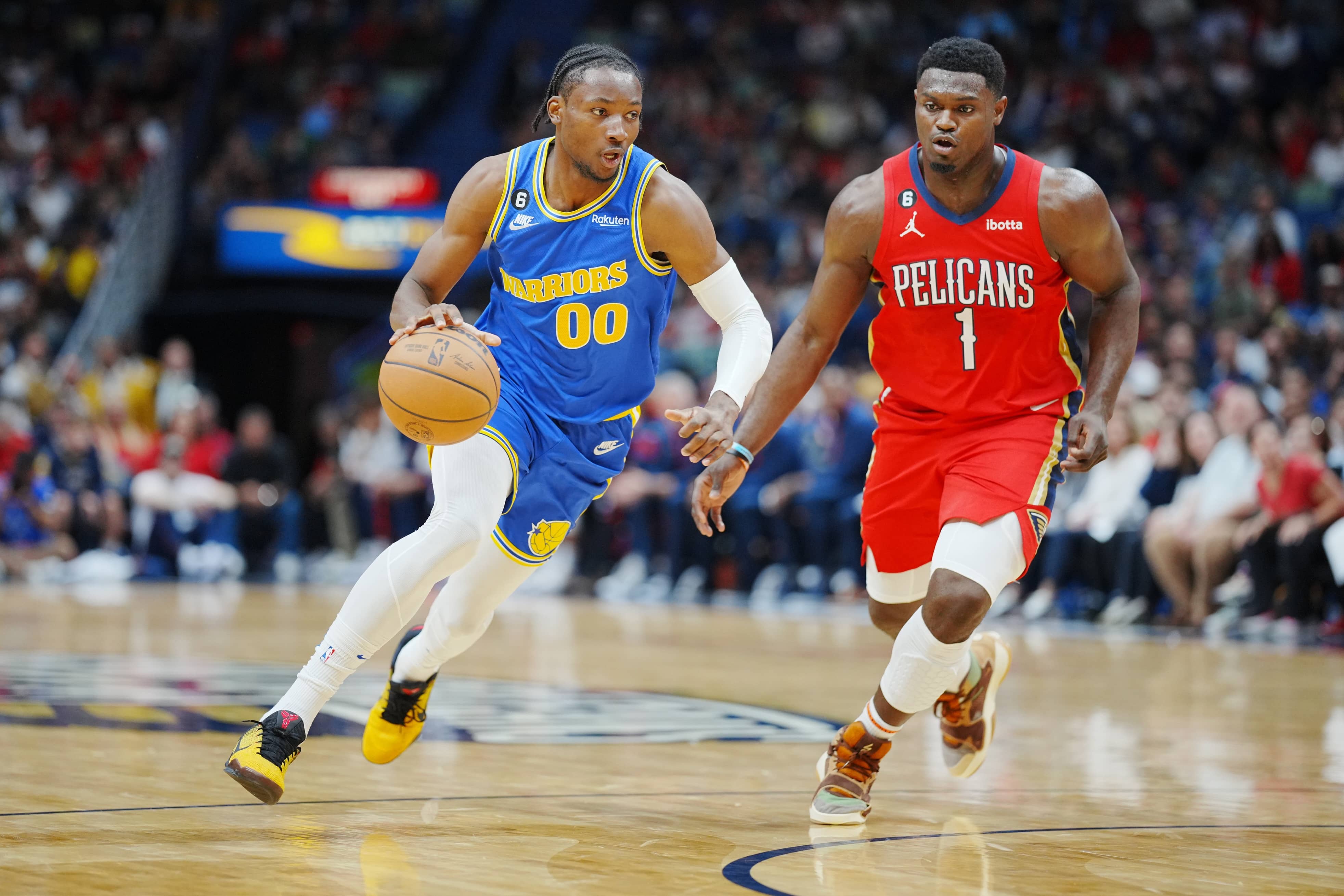Nov 4, 2022; New Orleans, Louisiana, USA; Golden State Warriors forward Jonathan Kuminga (00) drives to the basket against New Orleans Pelicans forward Zion Williamson (1) during the first quarter at Smoothie King Center.