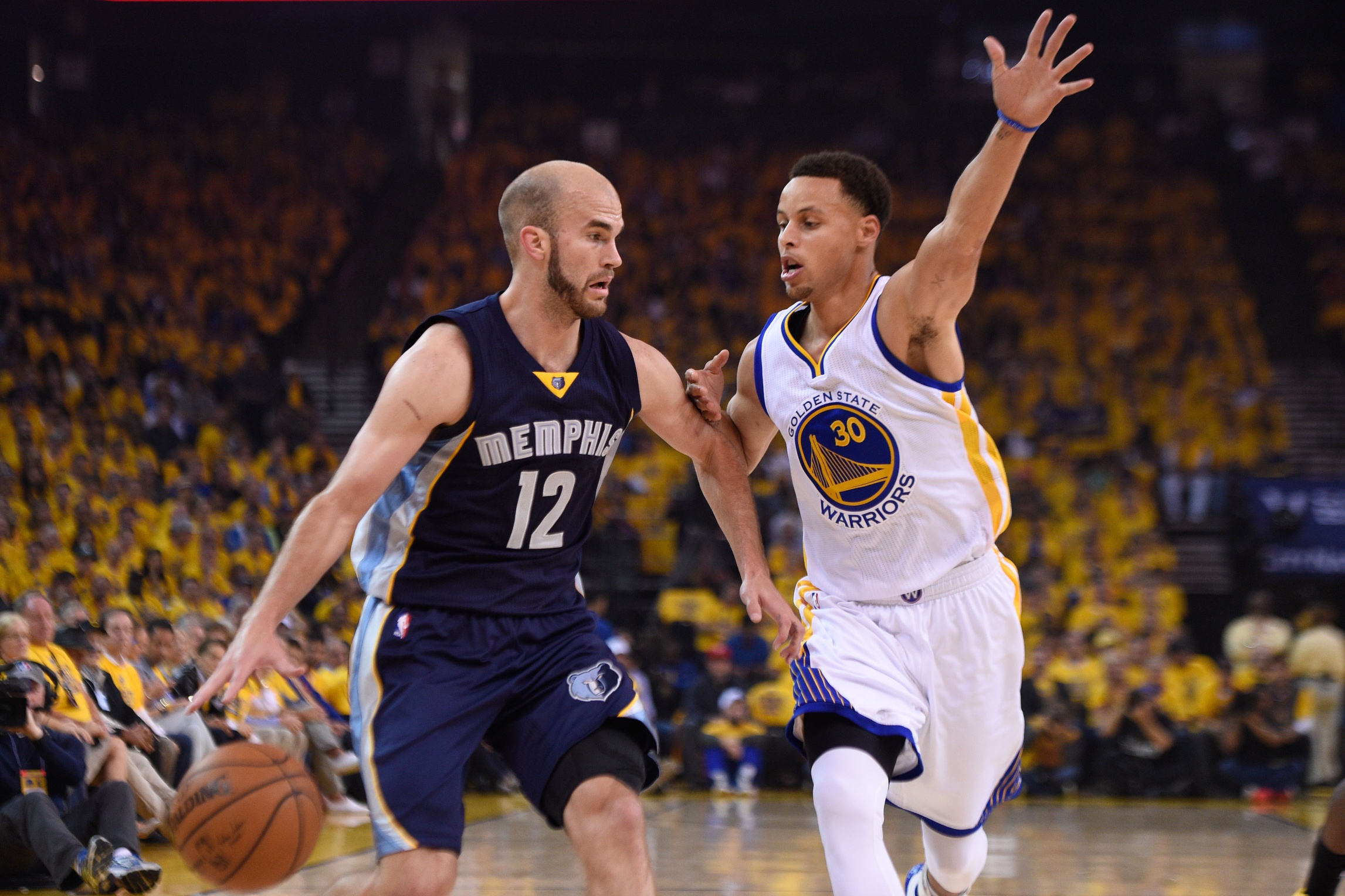 May 3, 2015; Oakland, CA, USA; Memphis Grizzlies guard Nick Calathes (12) dribbles the basketball against Golden State Warriors guard Stephen Curry (30) during the first quarter in game one of the second round of the NBA Playoffs