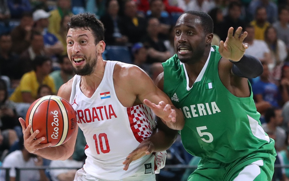 Aug 13, 2016; Rio de Janeiro, Brazil; Croatia point guard Roko Ukic (10) is defended by Nigeria guard Michael Umeh (5) during the men's preliminary game in the Rio 2016 Summer Olympic Games