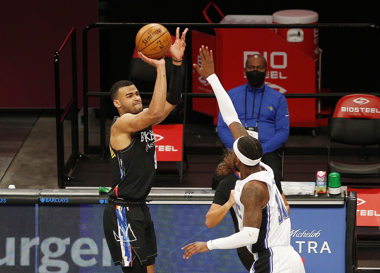 Feb 25, 2021; Brooklyn, New York, USA; Brooklyn Nets guard Timothe Luwawu-Cabarrot (9) takes a shot while being defended by Orlando Magic guard Terrence Ross (31) during the first half at Barclays Center.