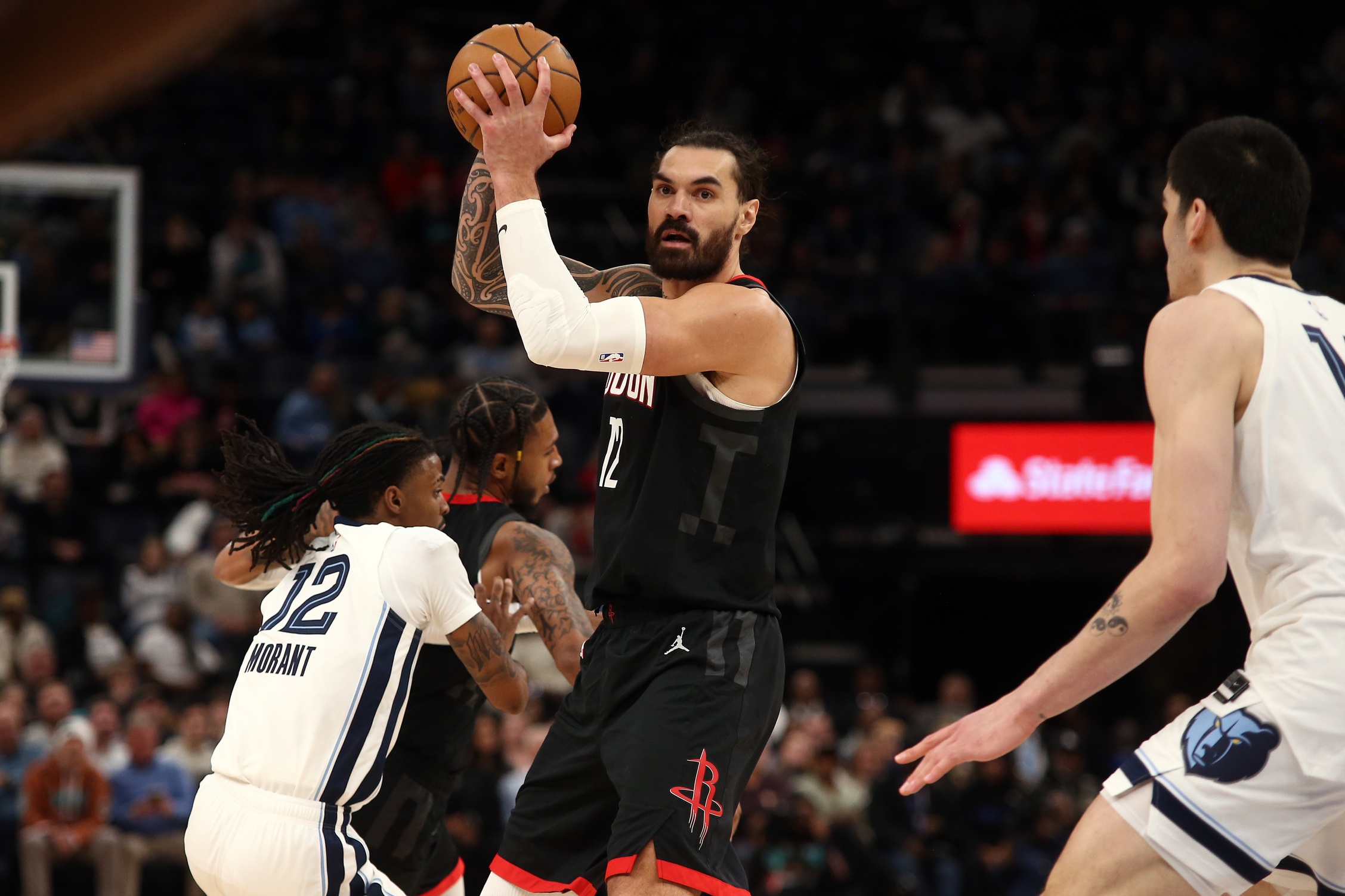 Houston Rockets center Steven Adams (12) handles the ball as Memphis Grizzlies center Zach Edey (14) defends during the fourth quarter at FedExForum. Mandatory Credit: Petre Thomas-Imagn Images