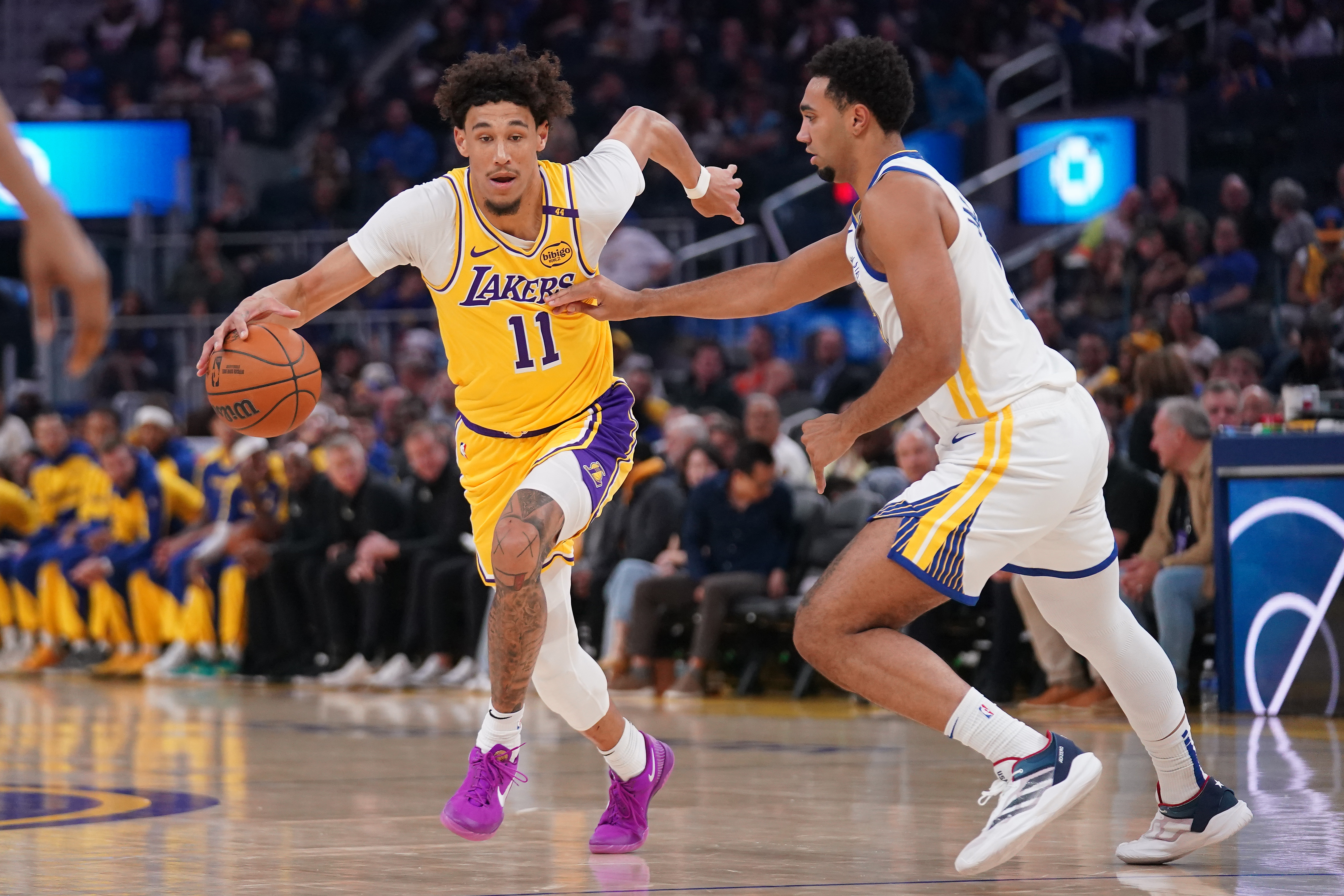 Oct 18, 2024; San Francisco, California, USA; Los Angeles Lakers center Jaxson Hayes (11) dribbles past Golden State Warriors forward Trayce Jackson-Davis (32) in the first quarter at the Chase Center. Mandatory Credit: Cary Edmondson-Imagn Images