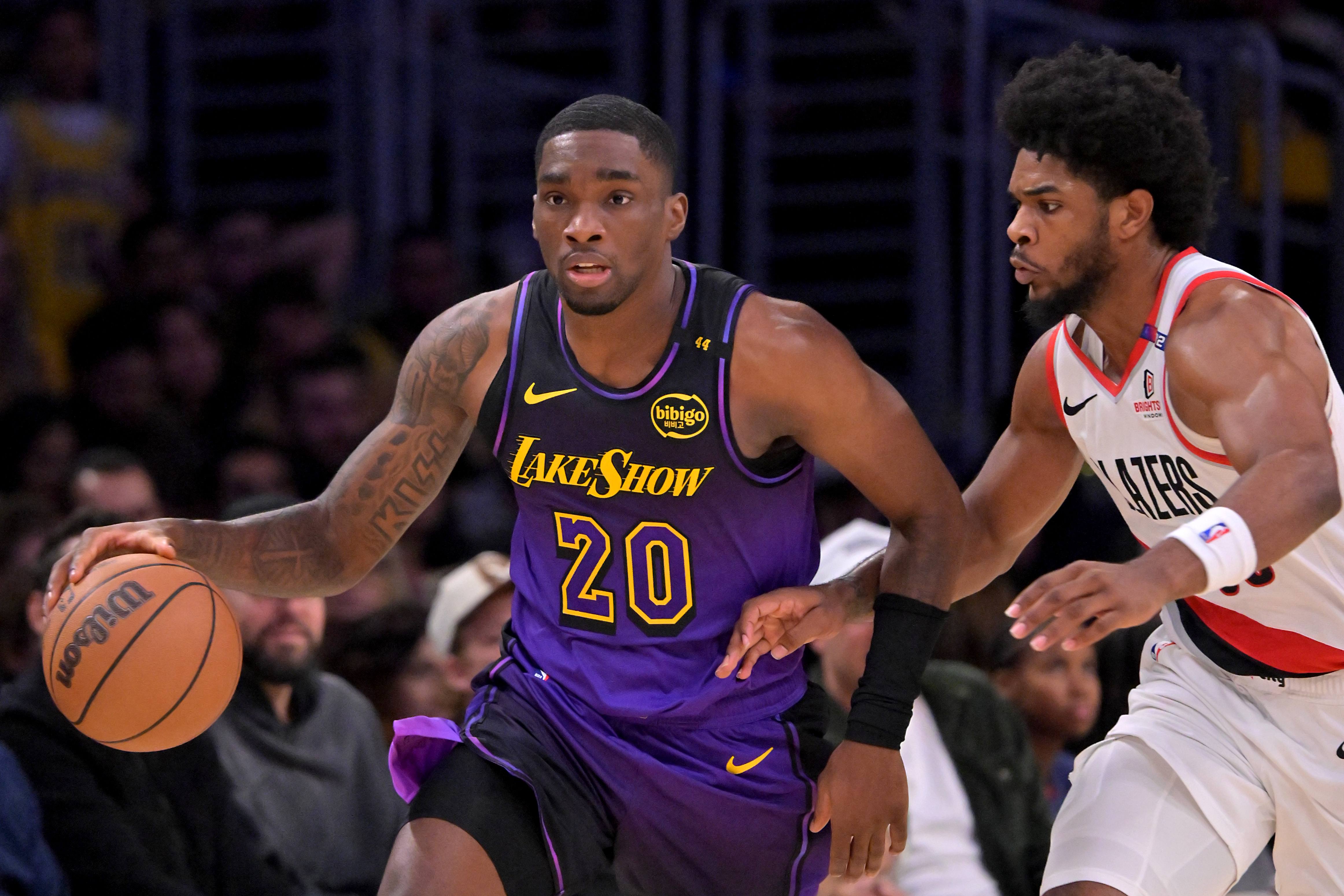 Jan 2, 2025; Los Angeles, California, USA; Los Angeles Lakers guard Shake Milton (20) drives past Portland Trail Blazers guard Scoot Henderson (00) in the second half at Crypto.com Arena. Mandatory Credit: Jayne Kamin-Oncea-Imagn Images
