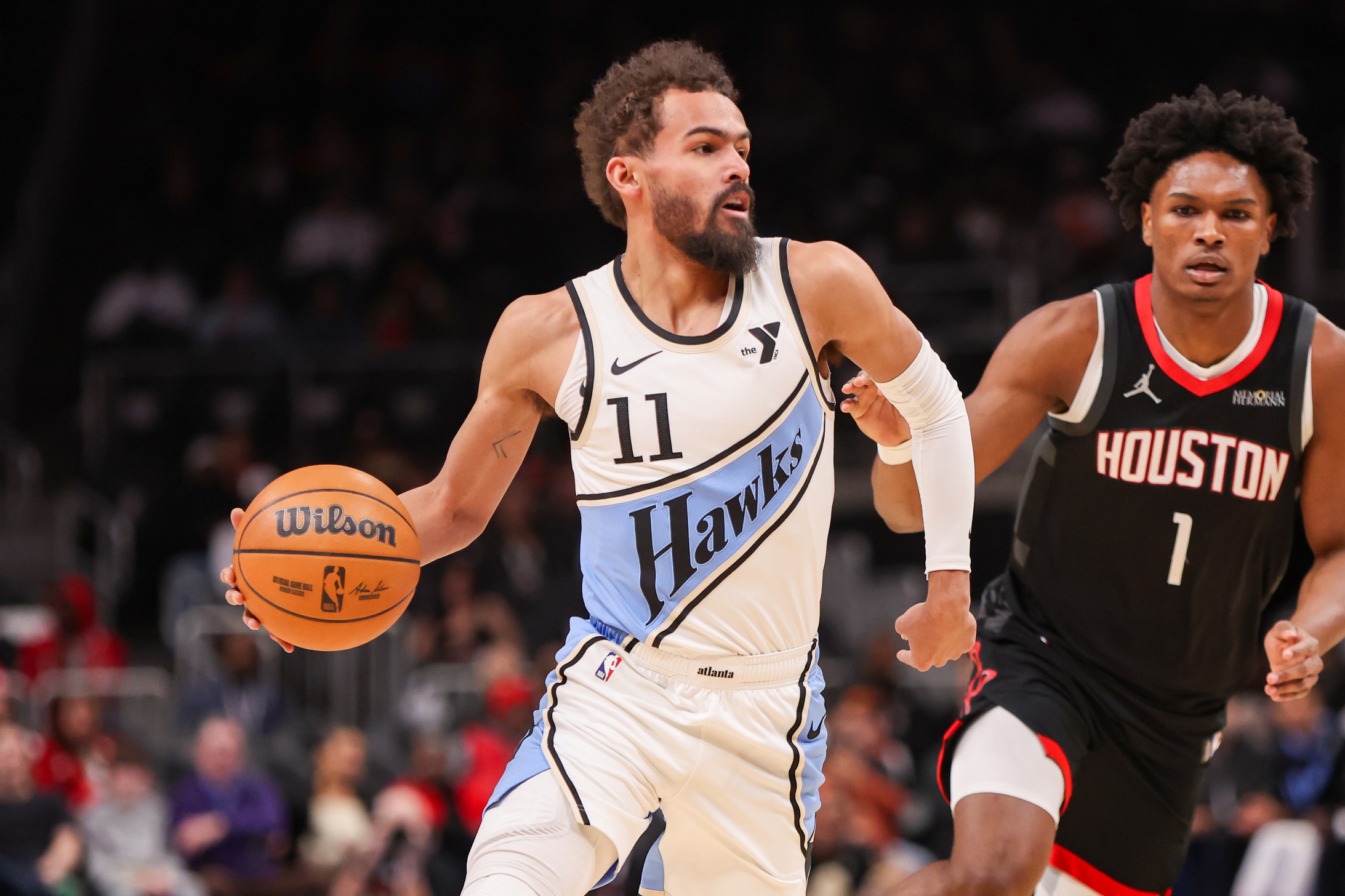 Atlanta Hawks guard Trae Young (11) is defended by Houston Rockets forward Amen Thompson (1) in the first quarter at State Farm Arena. Mandatory Credit: Brett Davis-Imagn Images