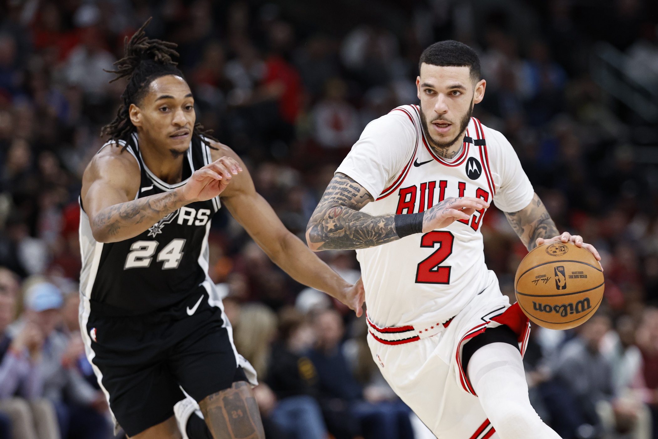Chicago Bulls guard Lonzo Ball (2) drives to the basket against San Antonio Spurs guard Devin Vassell (24) during the second half at United Center. Mandatory Credit: Kamil Krzaczynski-Imagn Images