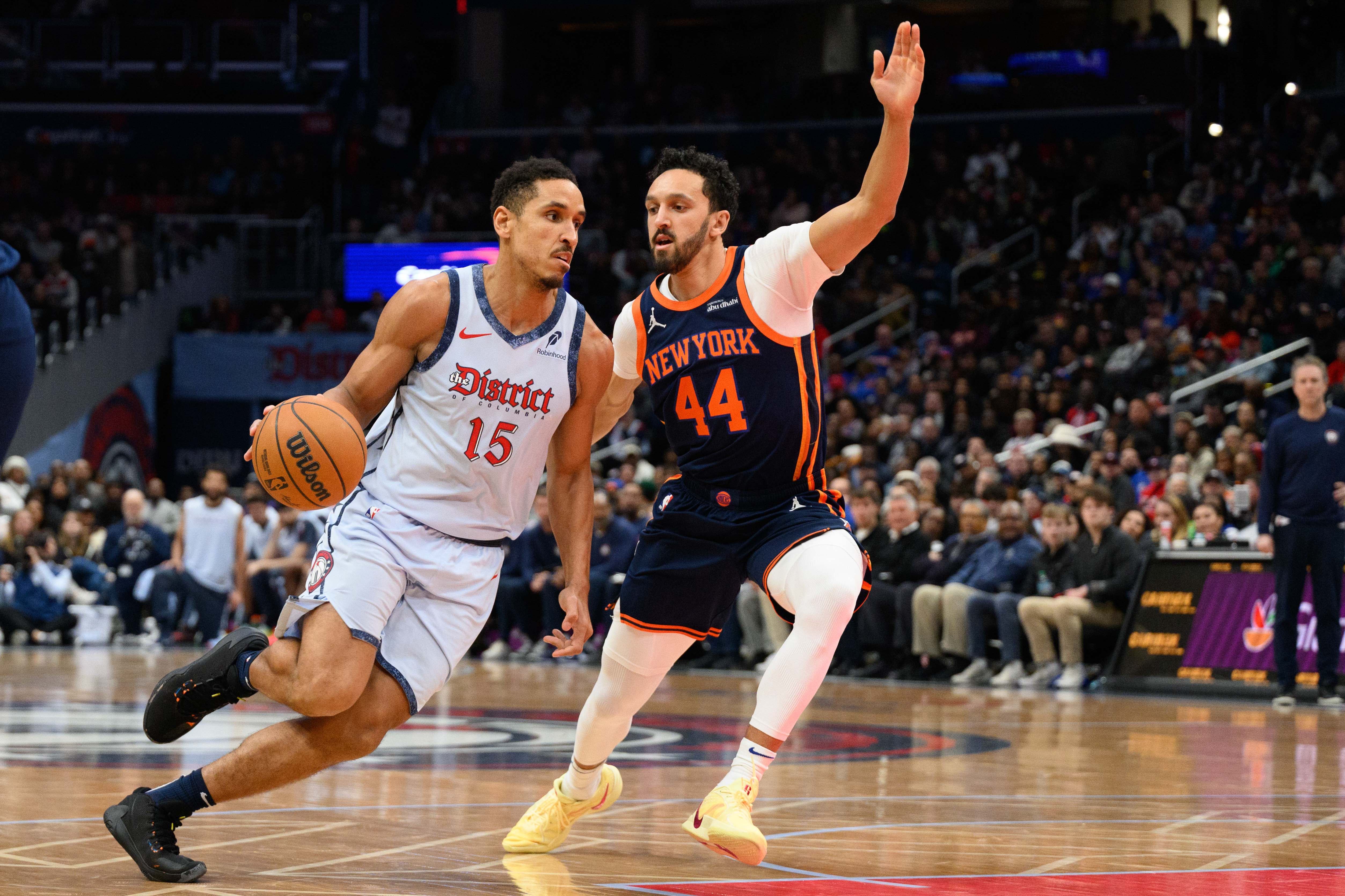 Dec 30, 2024; Washington, District of Columbia, USA; Washington Wizards guard Malcolm Brogdon (15) drives to the basket as New York Knicks guard Landry Shamet (44) defends during the third quarter at Capital One Arena. Mandatory Credit: Reggie Hildred-Imagn Images