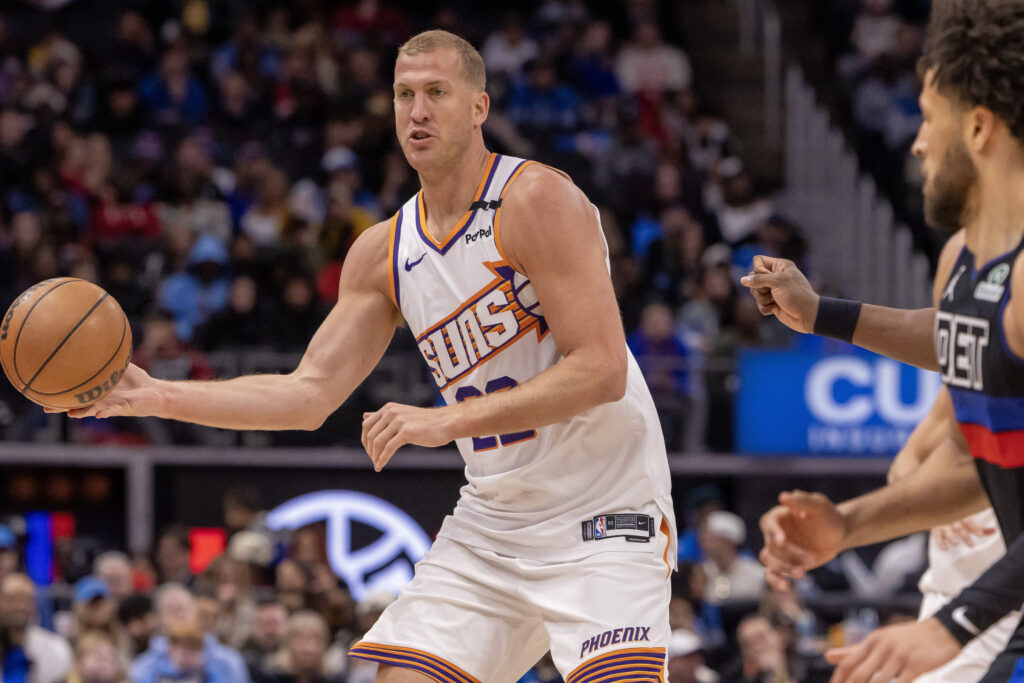 Jan 18, 2025; Detroit, Michigan, USA; Phoenix Suns center Mason Plumlee (22) passes the ball against the Detroit Pistons during the fourth quarter at Little Caesars Arena. Mandatory Credit: David Reginek-Imagn Images