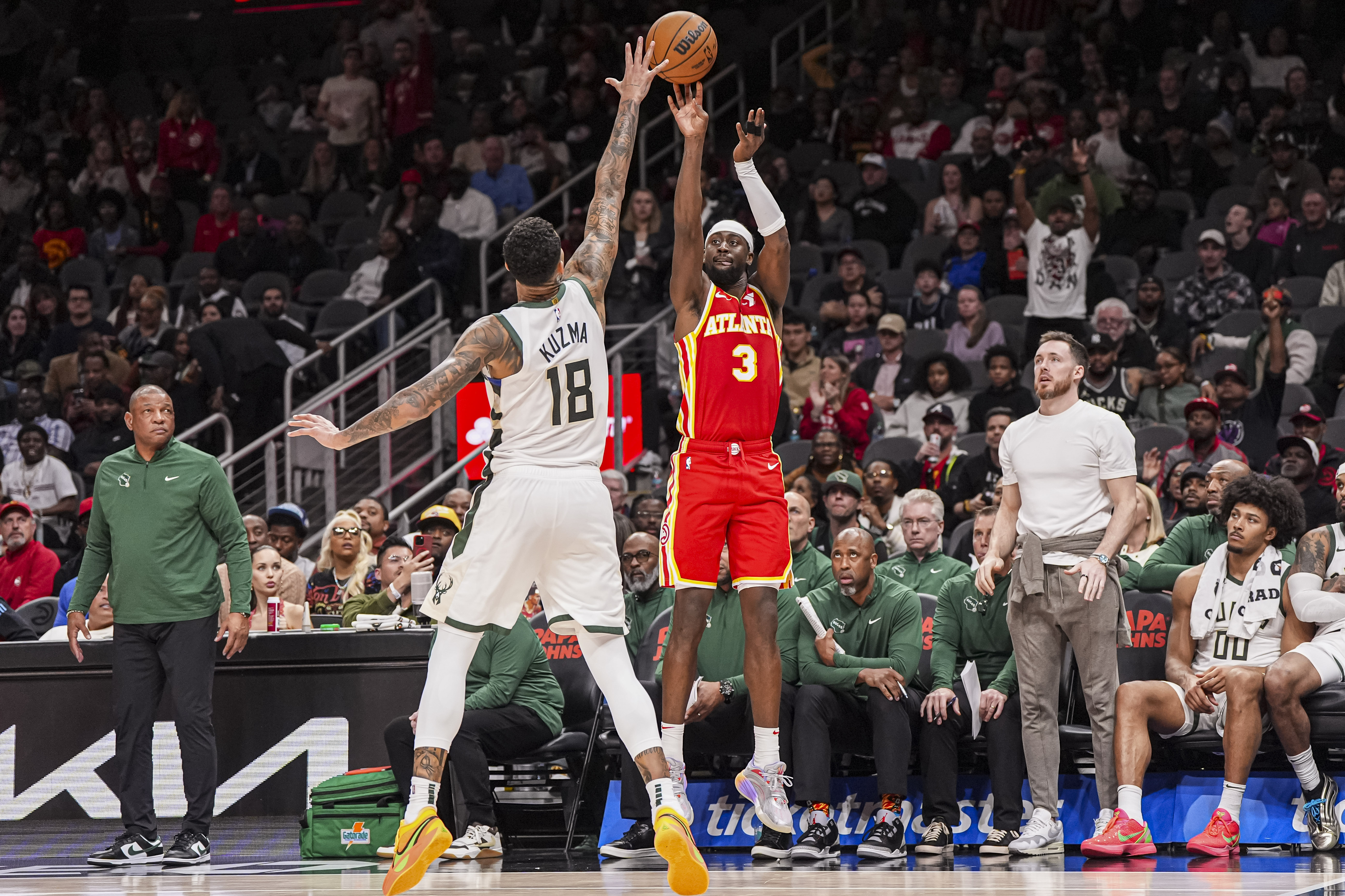 Mar 4, 2025; Atlanta, Georgia, USA; Atlanta Hawks guard Caris LeVert (3) shoots over Milwaukee Bucks forward Kyle Kuzma (18) during the second half at State Farm Arena. Mandatory Credit: Dale Zanine-Imagn Images  