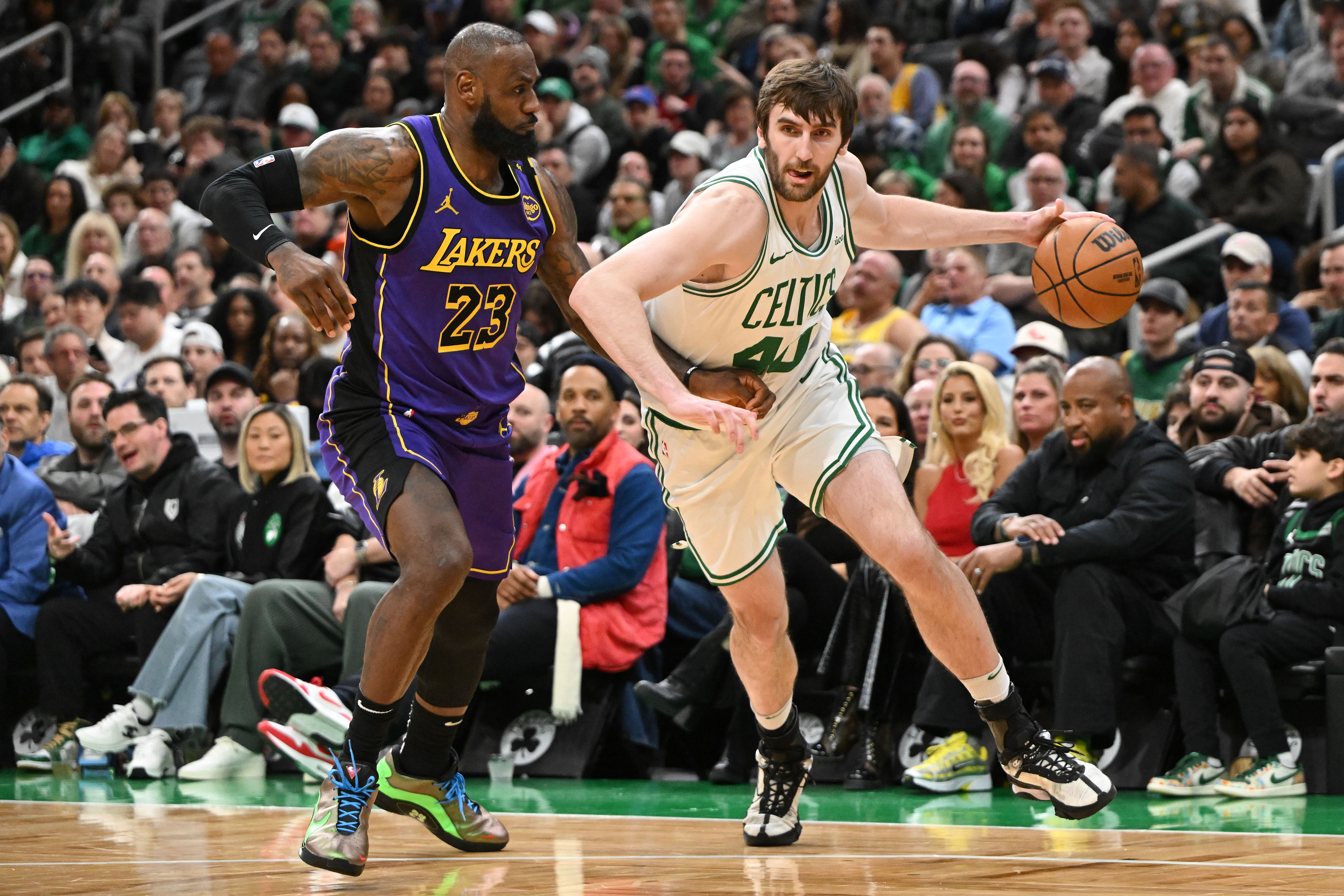 Mar 8, 2025; Boston, Massachusetts, USA; Boston Celtics center Luke Kornet (40) drives to the basket against Los Angeles Lakers forward LeBron James (23) during the fourth quarter at the TD Garden. Mandatory Credit: Brian Fluharty-Imagn Images