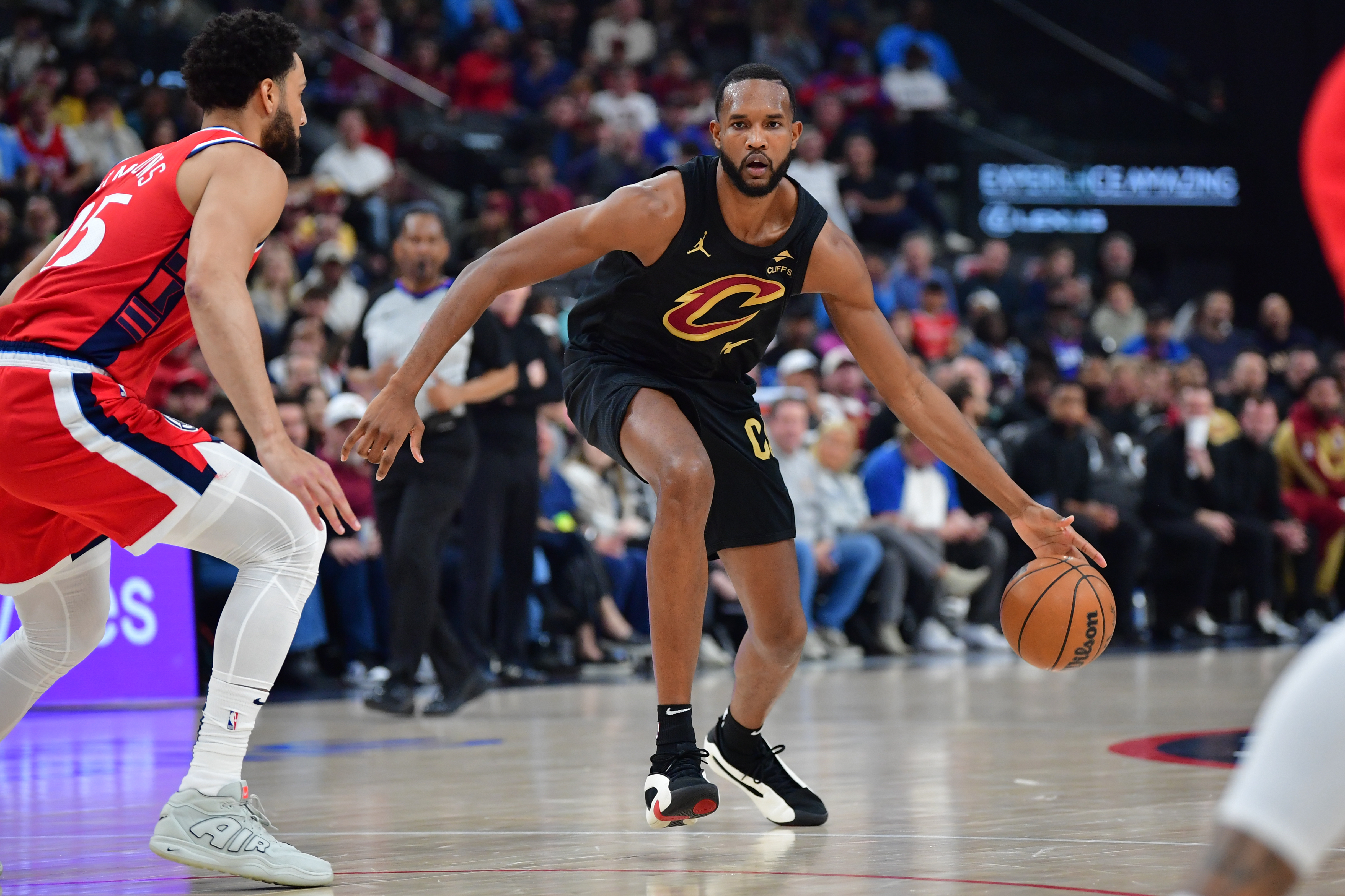 Mar 18, 2025; Inglewood, California, USA; Cleveland Cavaliers forward Evan Mobley (4) moves the ball against Los Angeles Clippers guard Ben Simmons (25) during the first half at Intuit Dome. Mandatory Credit: Gary A. Vasquez-Imagn Images  