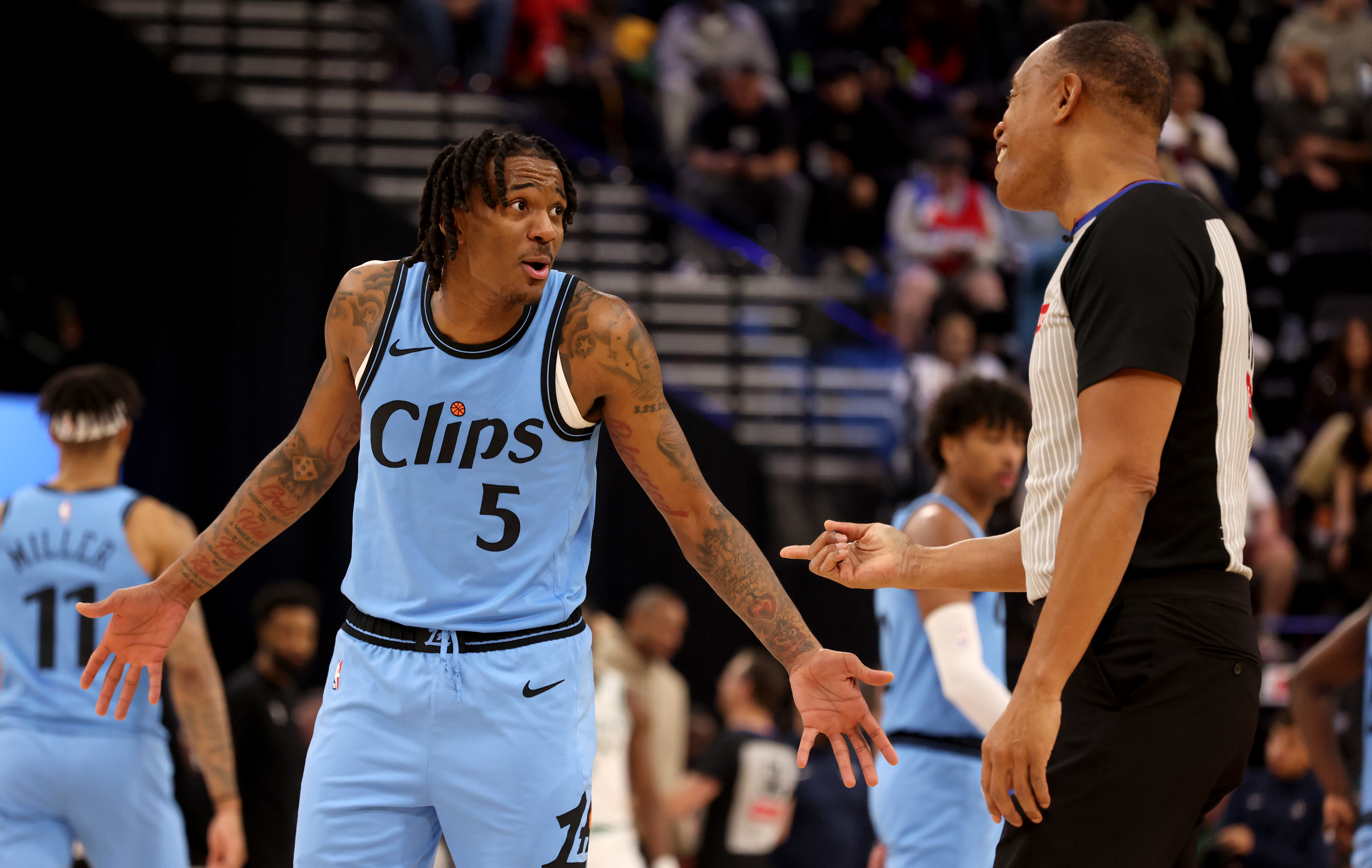 Jan 22, 2025; Inglewood, California, USA; LA Clippers guard Bones Hyland (5) talks to referee Rodney Mott (71) during the second quarter against the Boston Celtics at Intuit Dome. Mandatory Credit: Jason Parkhurst-Imagn Images