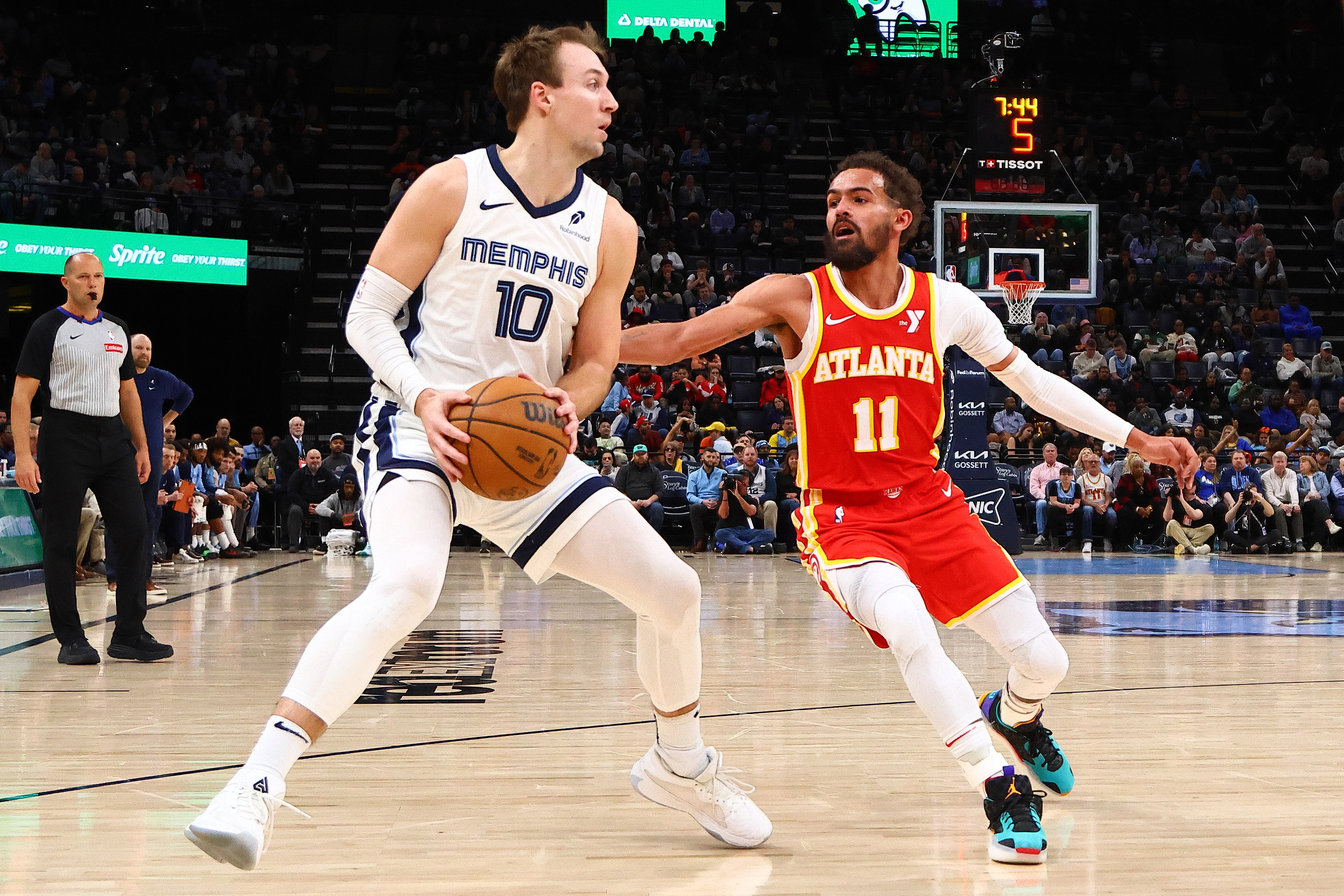 Mar 3, 2025; Memphis, Tennessee, USA; Memphis Grizzlies guard Luke Kennard (10) handles the ball as Atlanta Hawks guard Trae Young (11) defends during the third quarter at FedExForum. Mandatory Credit: Petre Thomas-Imagn Images