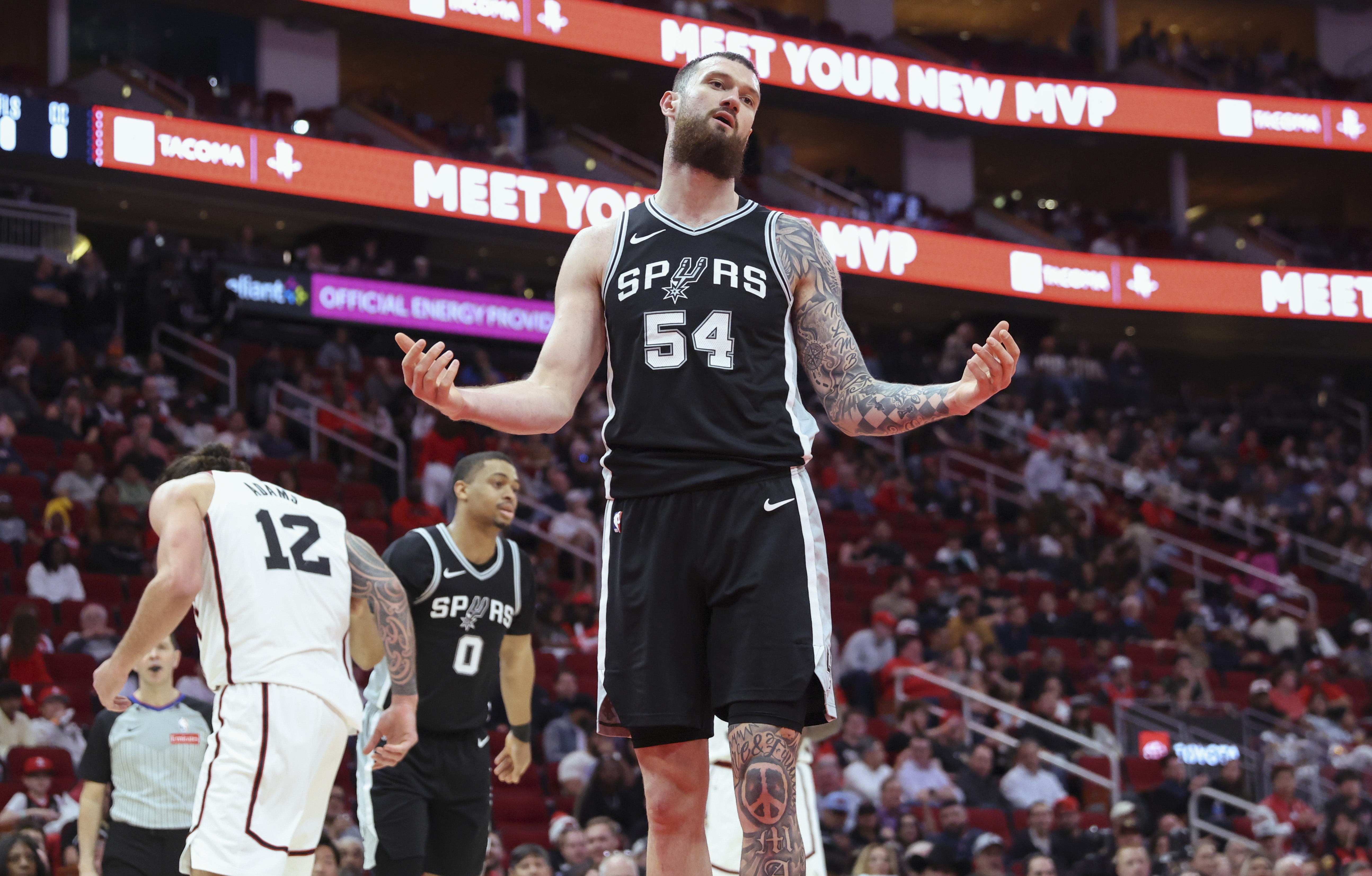 Feb 26, 2025; Houston, Texas, USA; San Antonio Spurs forward Sandro Mamukelashvili (54) reacts after a play during the fourth quarter against the Houston Rockets at Toyota Center. Mandatory Credit: Troy Taormina-Imagn Images