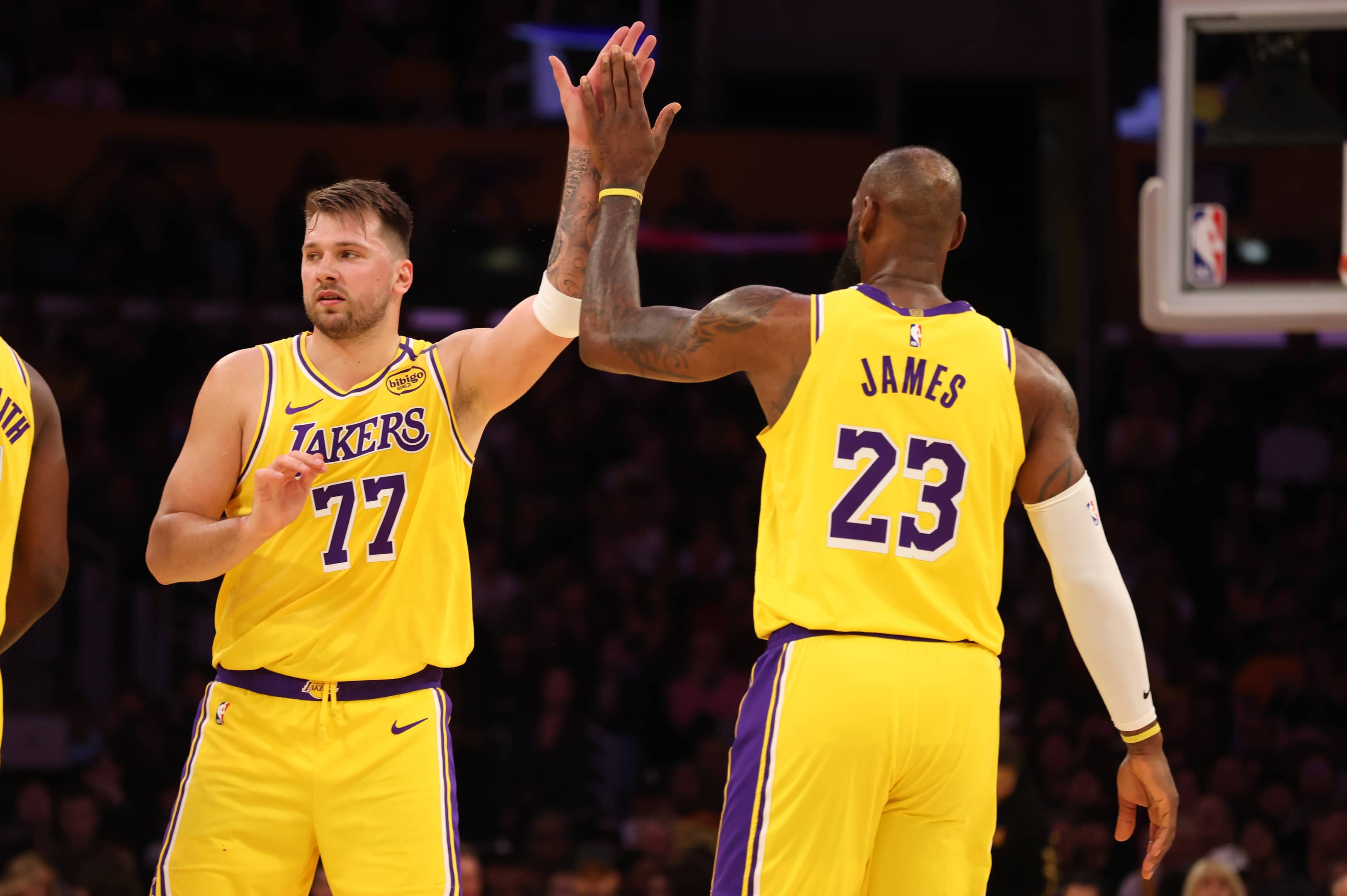 Los Angeles Lakers forward LeBron James (23) and guard Luka Doncic (77) react after a play during the first quarter against the Minnesota Timberwolves at Crypto.com Arena.