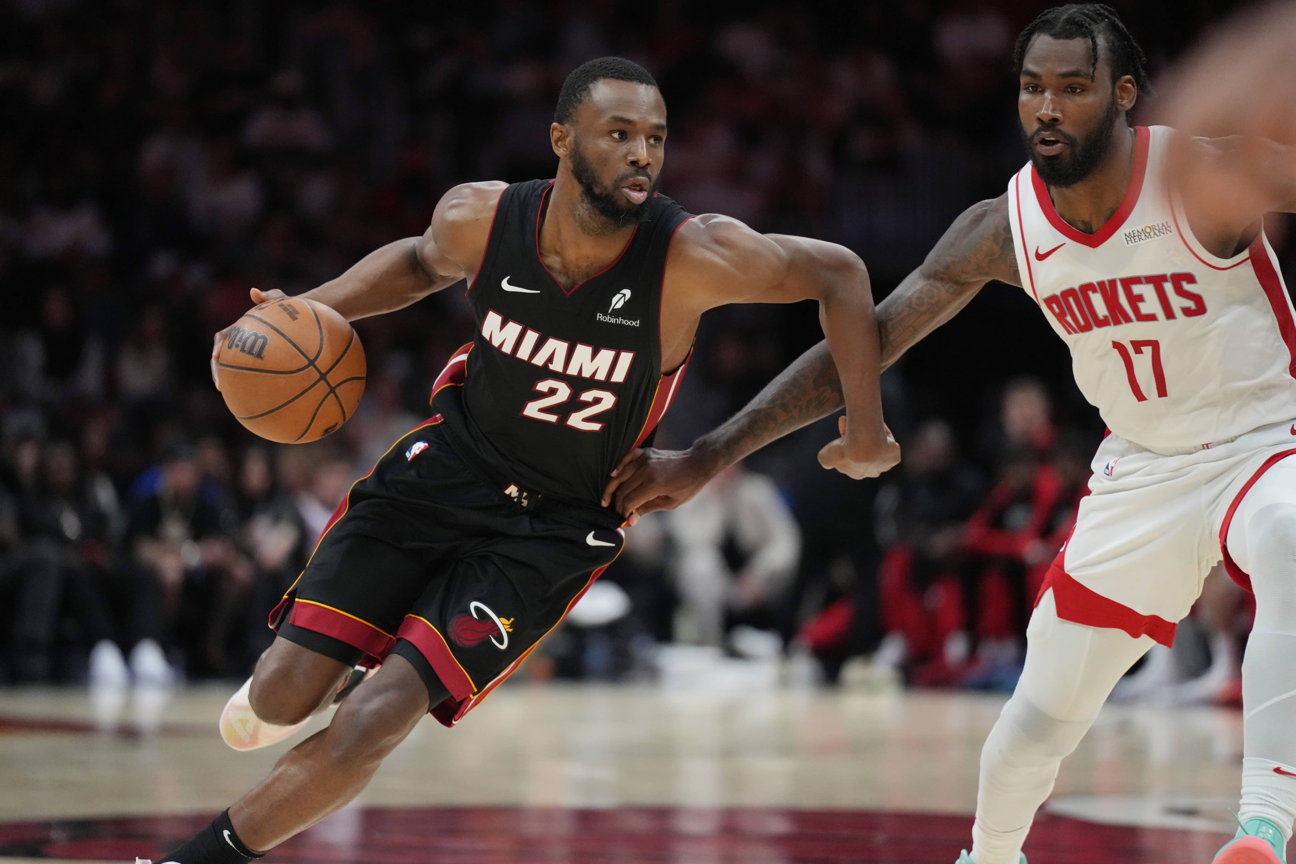 Mar 21, 2025; Miami, Florida, USA; Miami Heat forward Andrew Wiggins (22) drives past Houston Rockets forward Tari Eason (17) in the second half at Kaseya Center. Mandatory Credit: Jim Rassol-Imagn Images