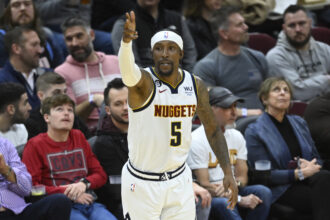 Feb 23, 2023; Cleveland, Ohio, USA; Denver Nuggets guard Kentavious Caldwell-Pope (5) celebrates his three-point basket in the fourth quarter against the Cleveland Cavaliers at Rocket Mortgage FieldHouse. Mandatory Credit: David Richard-Imagn Images