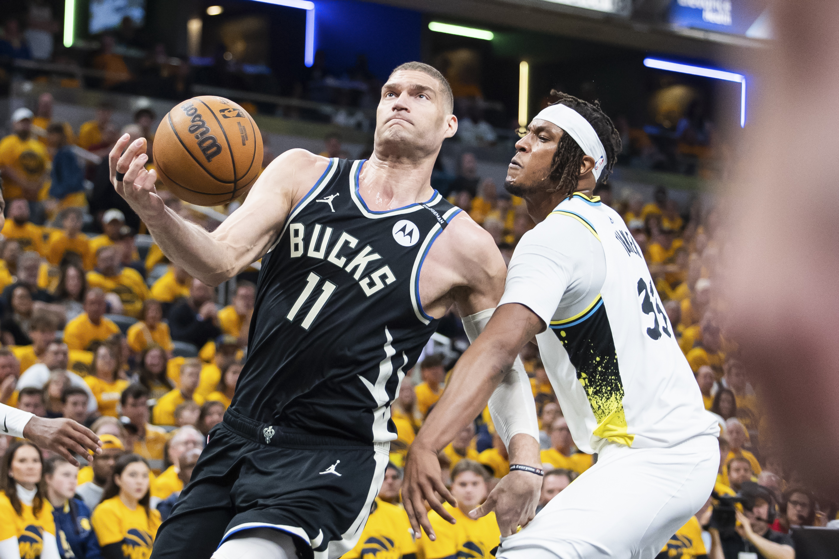 Apr 19, 2025; Indianapolis, Indiana, USA; Milwaukee Bucks center Brook Lopez (11) shoots the ball while Indiana Pacers center Myles Turner (33) defends in the first half at Gainbridge Fieldhouse. Mandatory Credit: Trevor Ruszkowski-Imagn Images