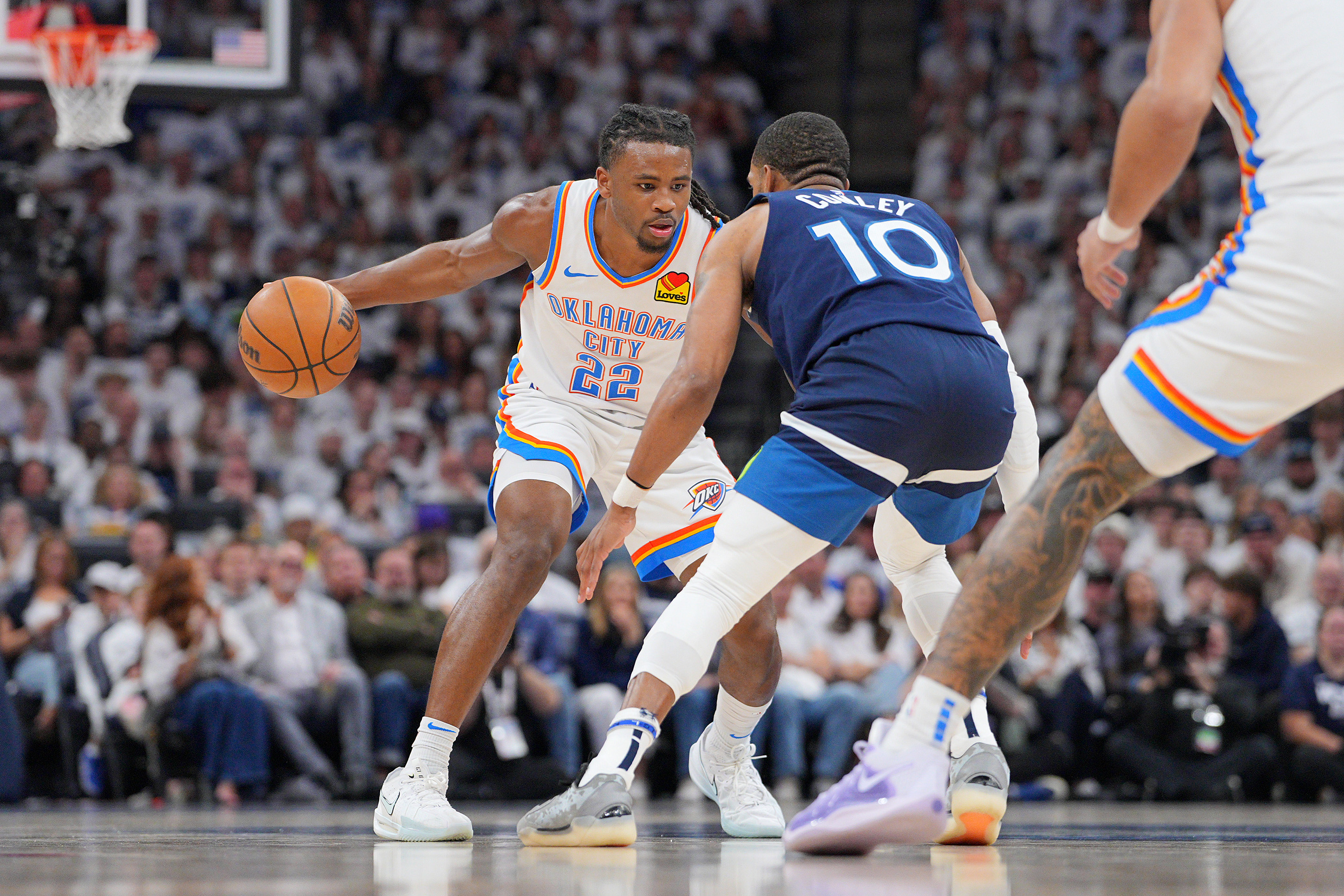 May 24, 2025; Minneapolis, Minnesota, USA; Oklahoma City Thunder guard Cason Wallace (22) dribbles the ball against Minnesota Timberwolves guard Mike Conley (10) during the first half in game three of the western conference finals for the 2025 NBA Playoffs at Target Center. Mandatory Credit: Brad Rempel-Imagn Images