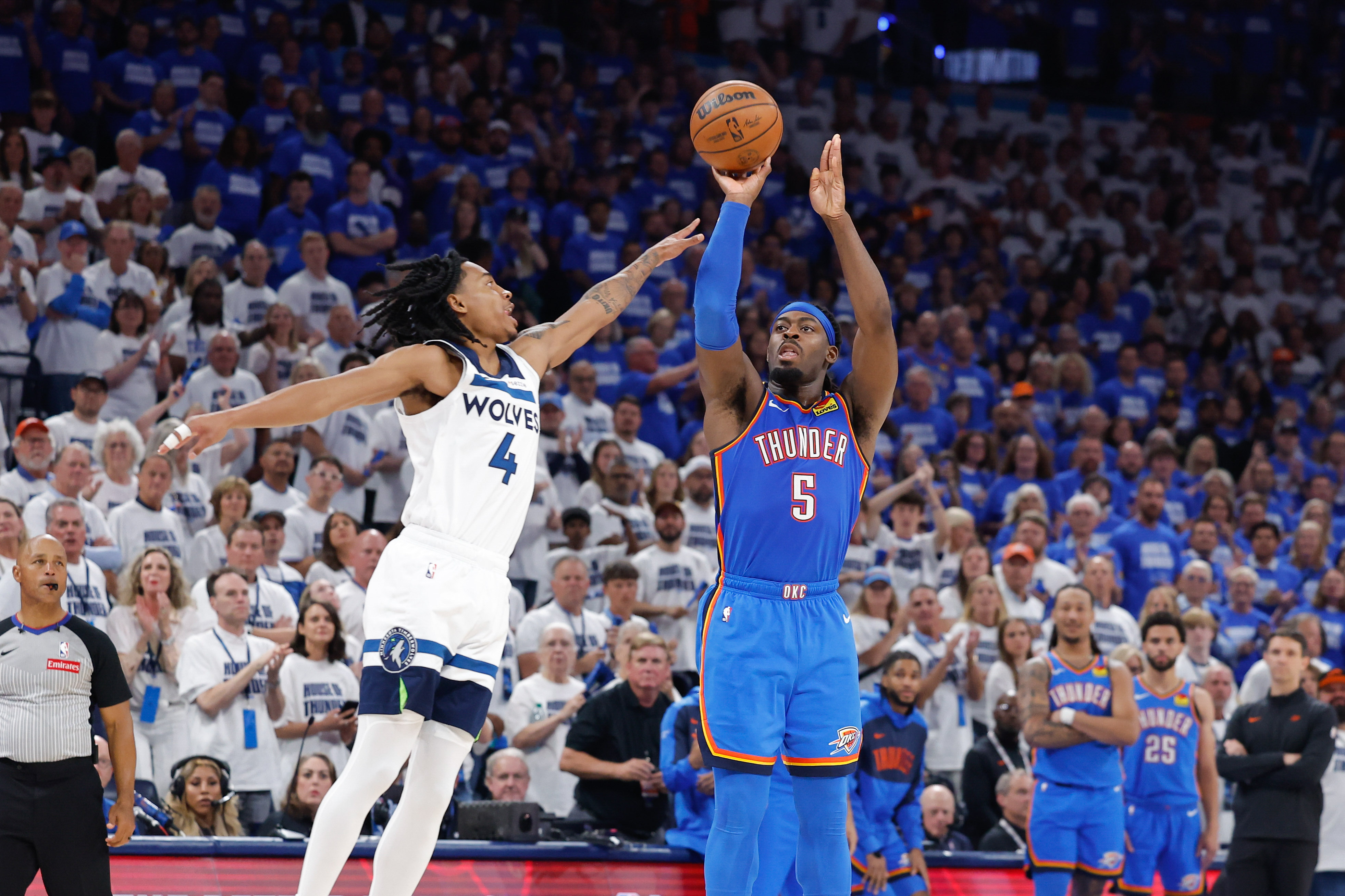 May 28, 2025; Oklahoma City, Oklahoma, USA; Oklahoma City Thunder guard Luguentz Dort (5) shoots as Minnesota Timberwolves guard Rob Dillingham (4) defends in the fourth quarter during game five of the western conference finals for the 2025 NBA Playoffs at Paycom Center. Mandatory Credit: Alonzo Adams-Imagn Images