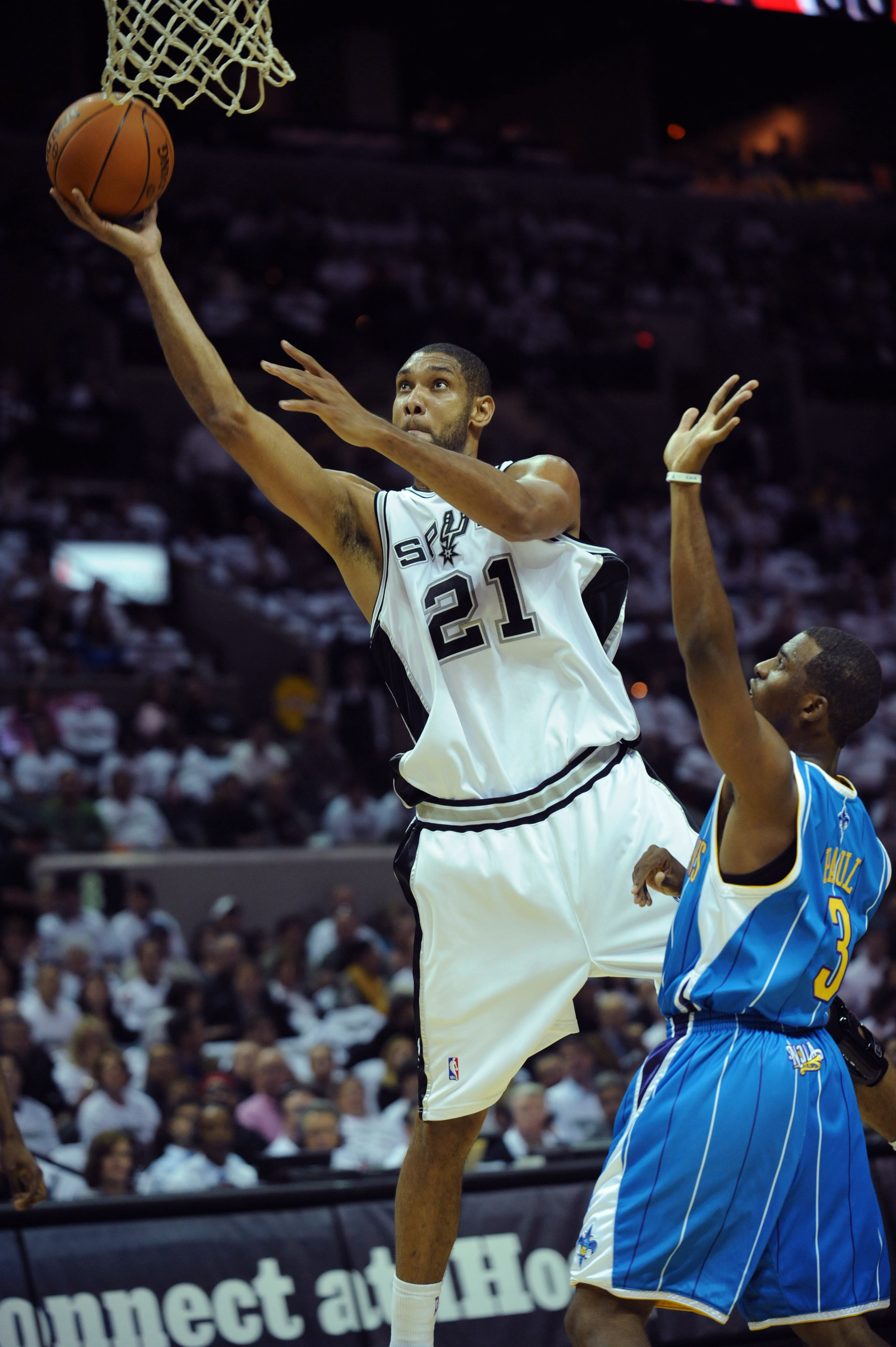 Oct 28, 2009; San Antonio, TX, USA; San Antonio Spurs forward Tim Duncan (21) shoots over New Orleans Hornets guard Chris Paul (3) during the first half at the AT&T Center. Mandatory Credit: Brendan Maloney-Imagn Images