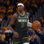 Minnesota Timberwolves forward Jaden McDaniels (3) dribbles upcourt against the Golden State Warriors.