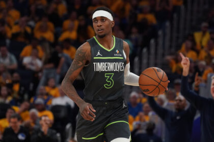 Minnesota Timberwolves forward Jaden McDaniels (3) dribbles upcourt against the Golden State Warriors.