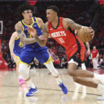 Houston Rockets forward Jabari Smith Jr. (10) drives with the ball as Golden State Warriors forward Gui Santos (15) defends during the third quarter at Toyota Center.