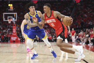 Houston Rockets forward Jabari Smith Jr. (10) drives with the ball as Golden State Warriors forward Gui Santos (15) defends during the third quarter at Toyota Center.